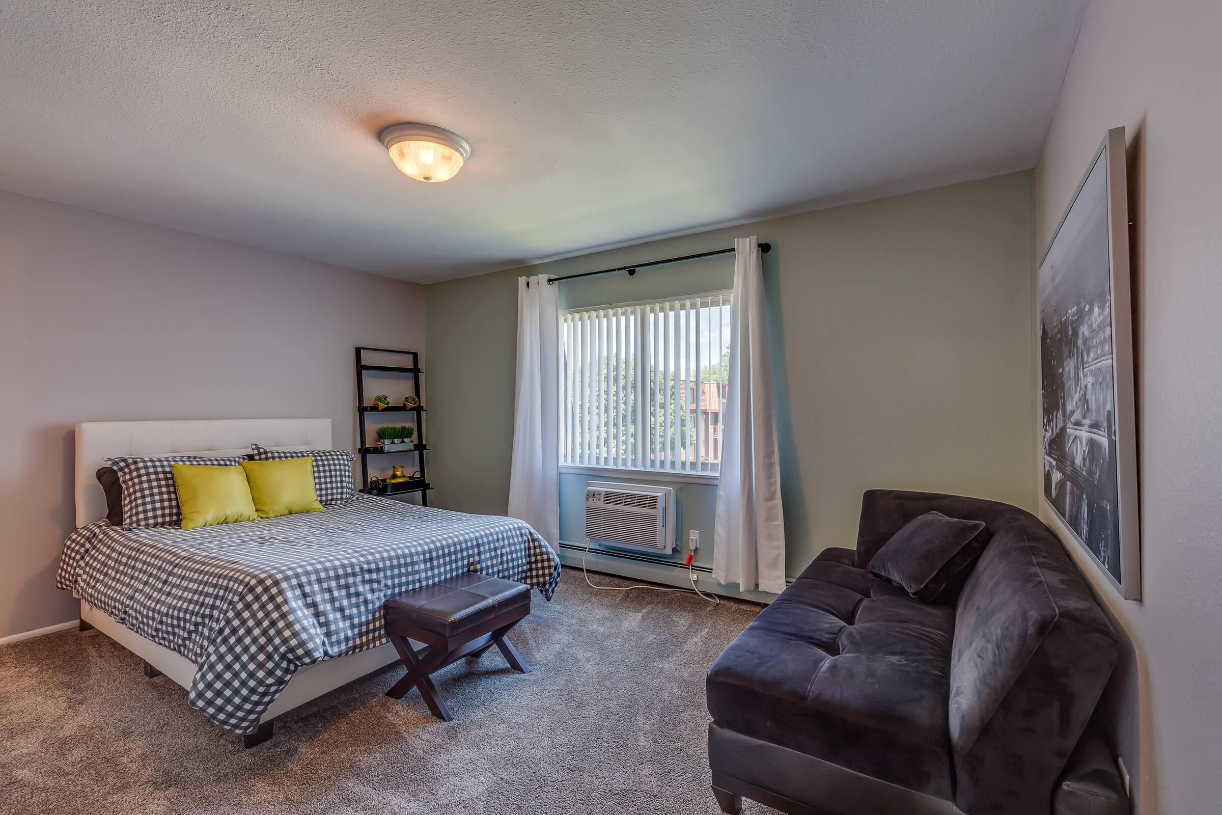 a living room filled with furniture and a large window