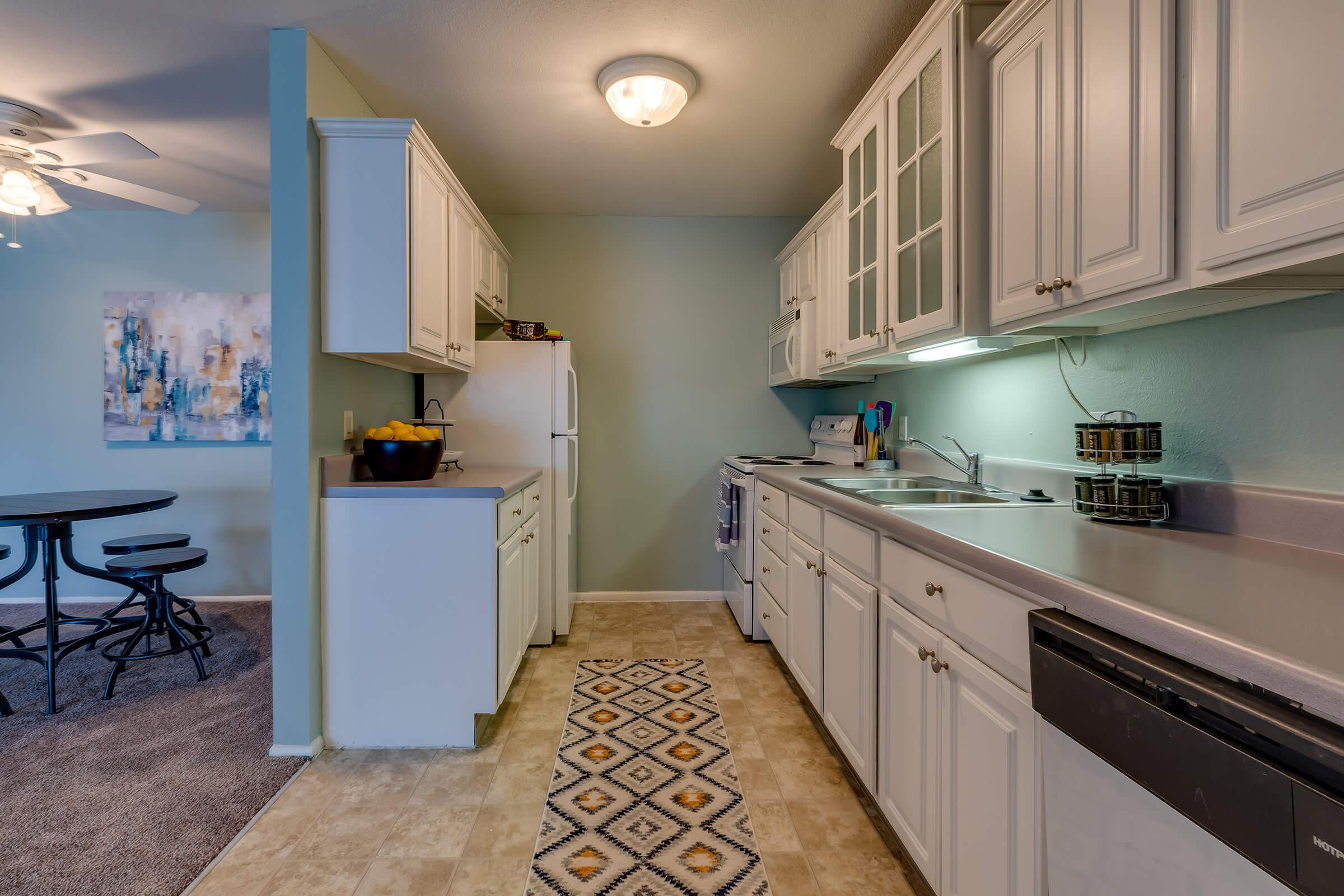 a kitchen with a stove top oven sitting inside of a room