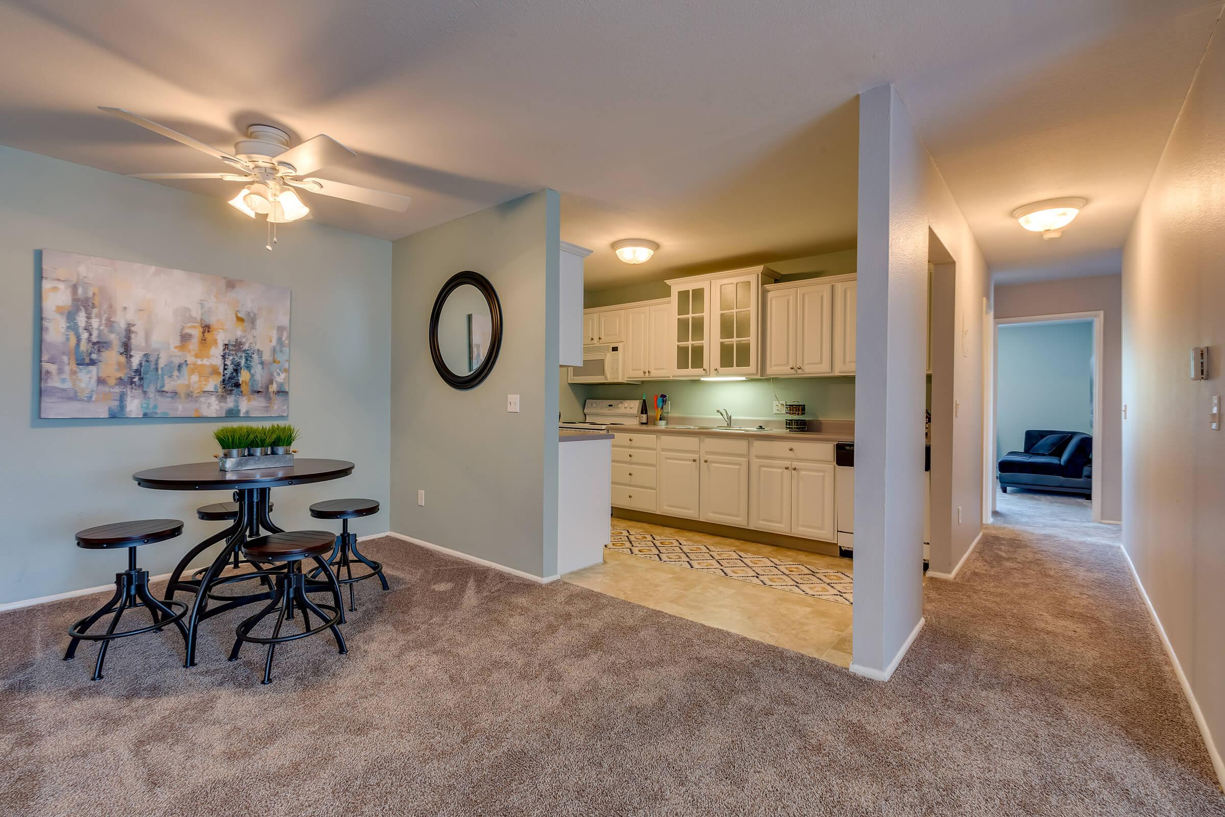 a living room filled with furniture and a mirror