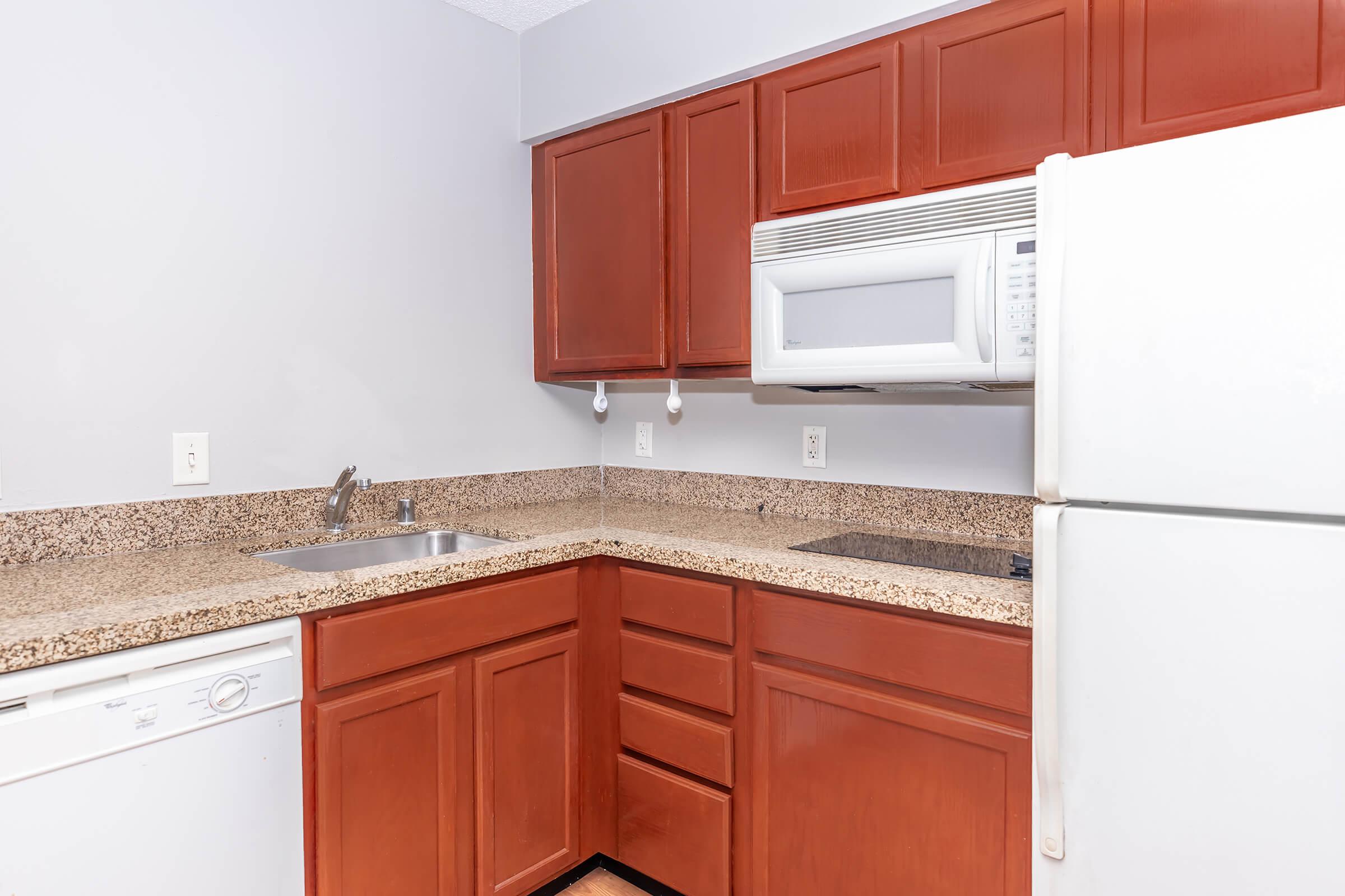 a kitchen with a stove and a refrigerator