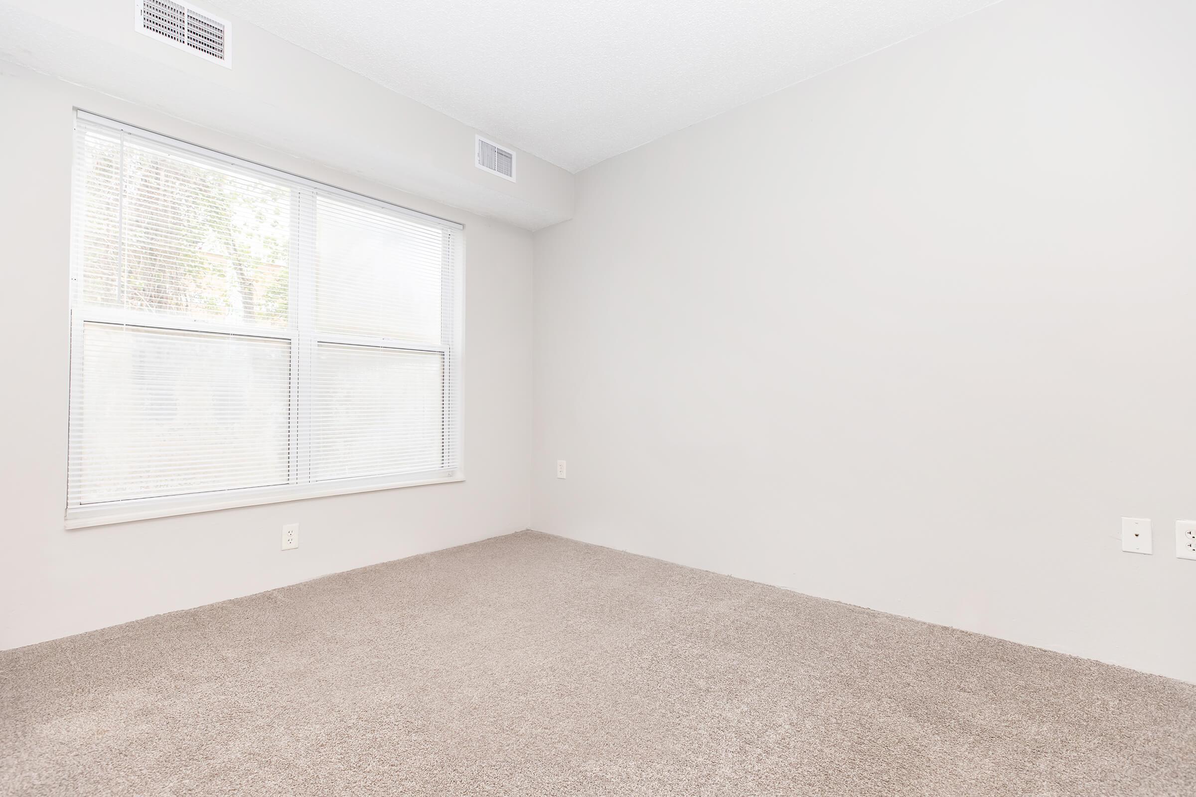 a bedroom with a large window