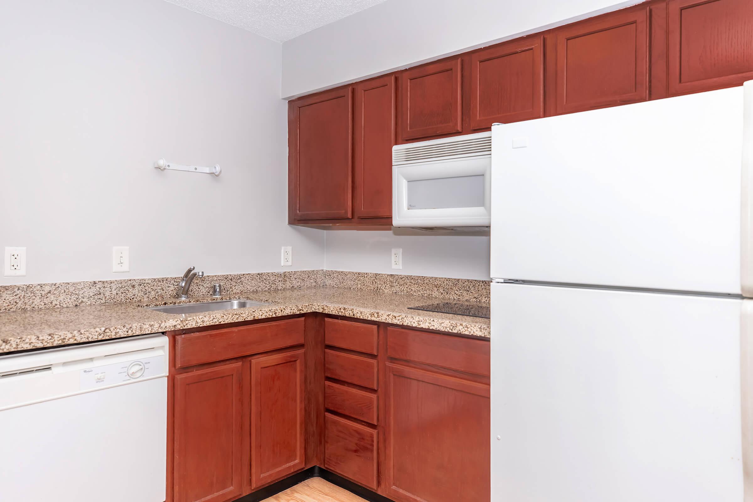 a kitchen with a stove and a refrigerator