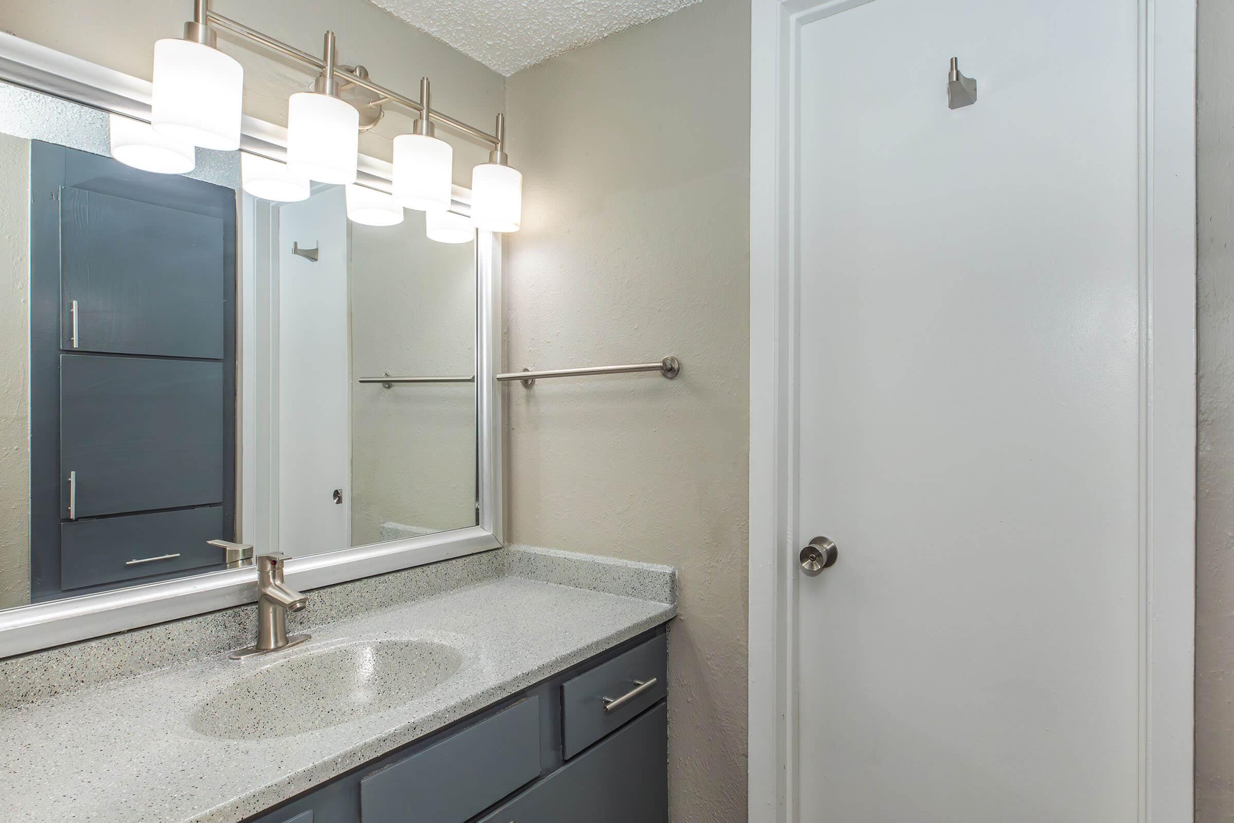 a shower that has a sink and a mirror