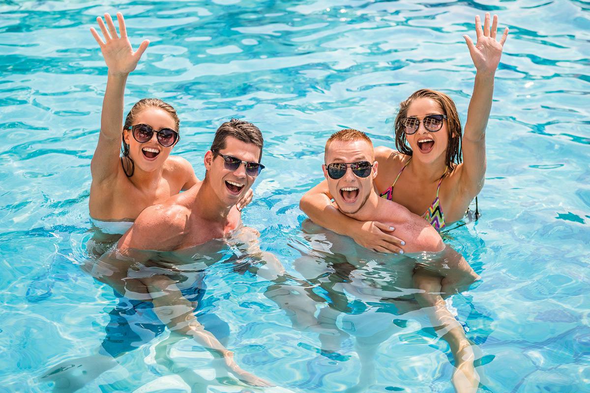 a group of people swimming in a pool of water