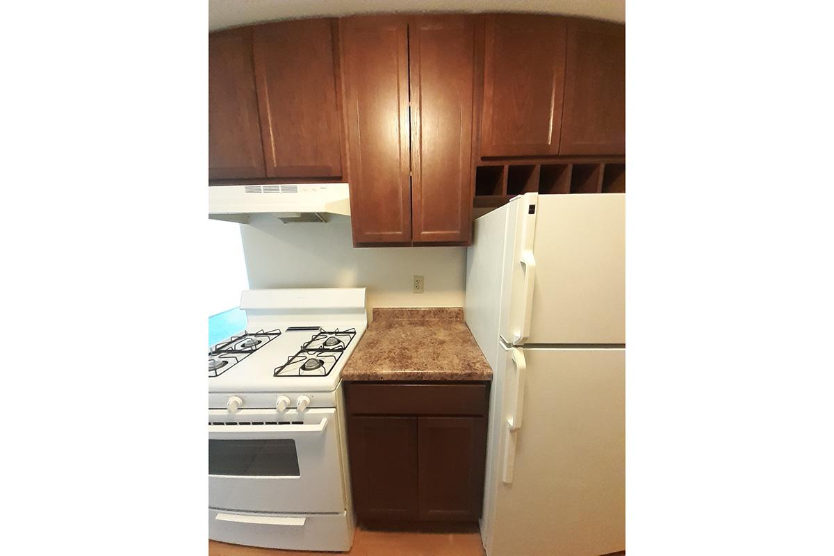 a kitchen with a stove top oven sitting inside of a refrigerator