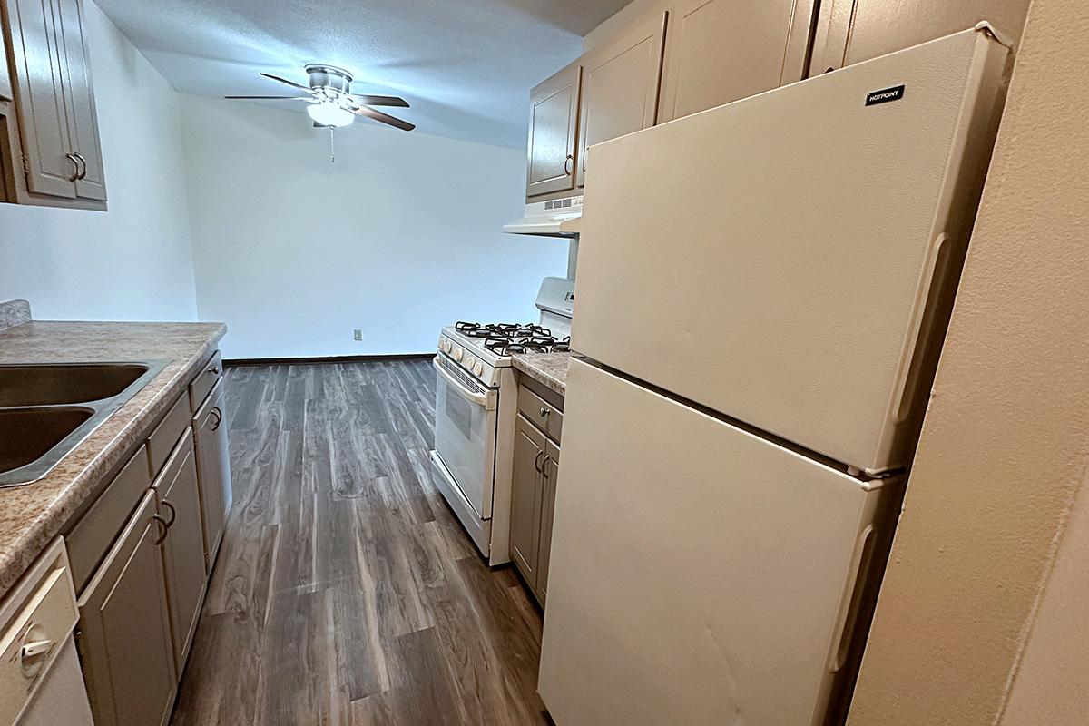 a kitchen with a sink and a refrigerator