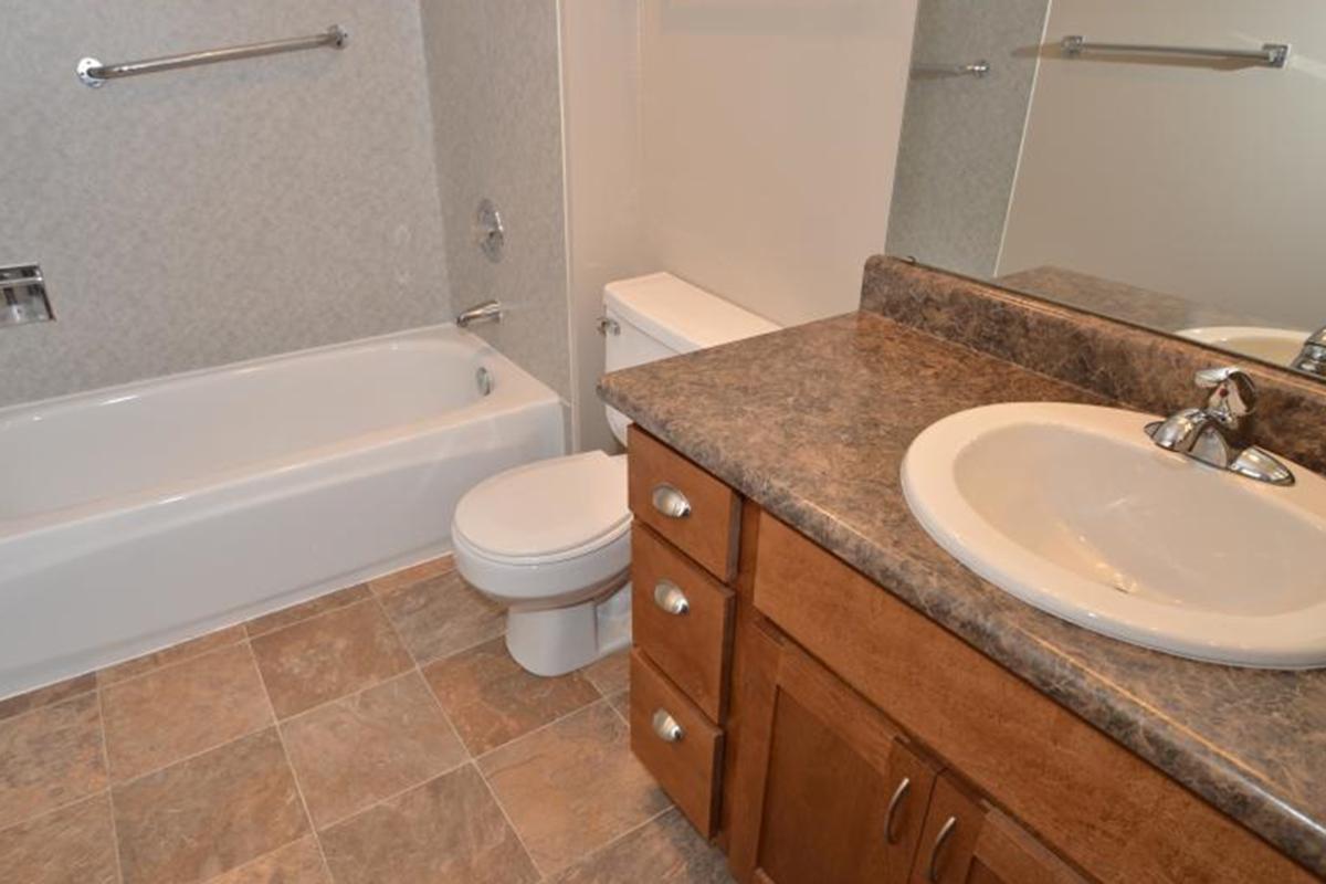 a large white tub sitting next to a sink