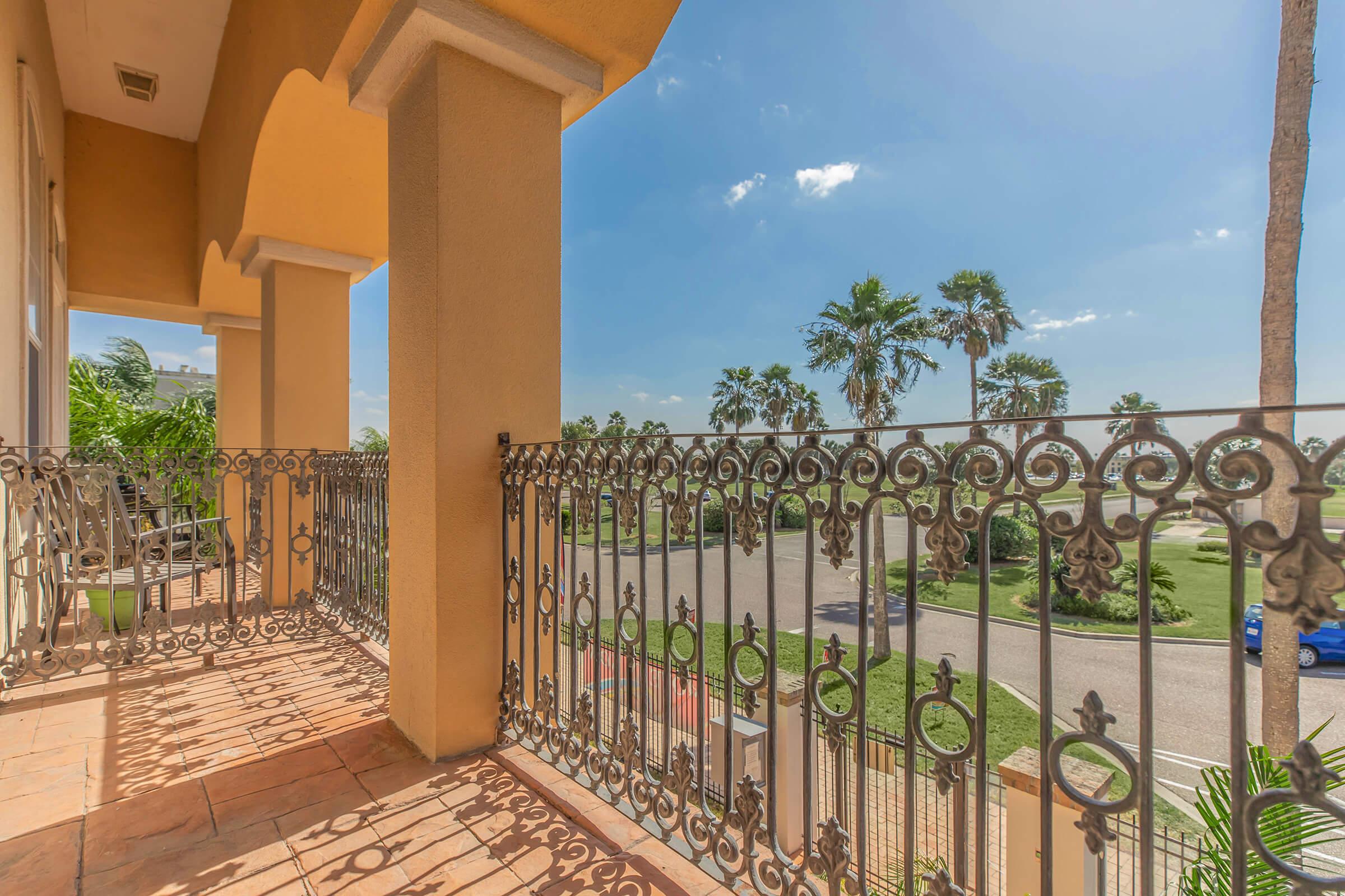 a group of palm trees and a fence