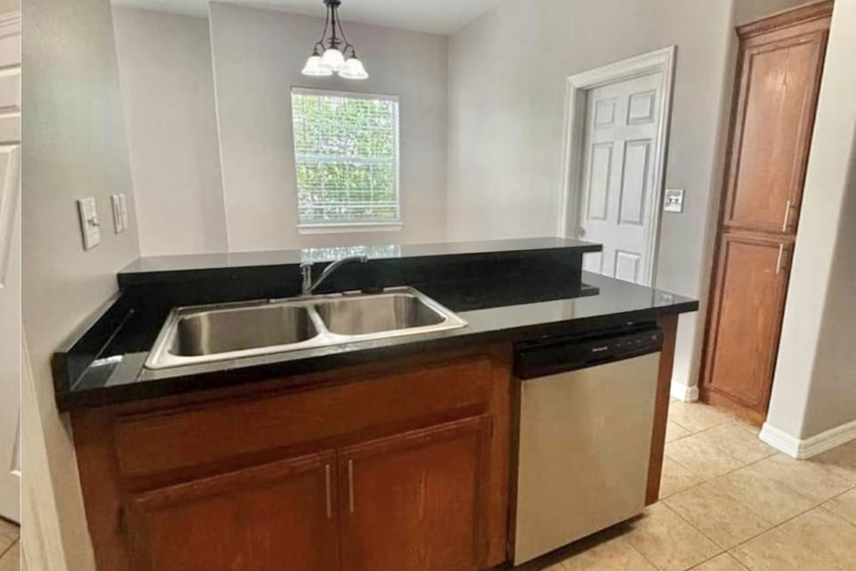 a kitchen with stainless steel appliances and wooden cabinets