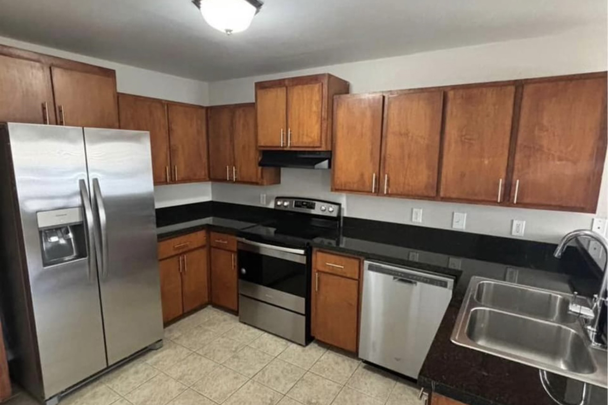 a kitchen with stainless steel appliances and wooden cabinets