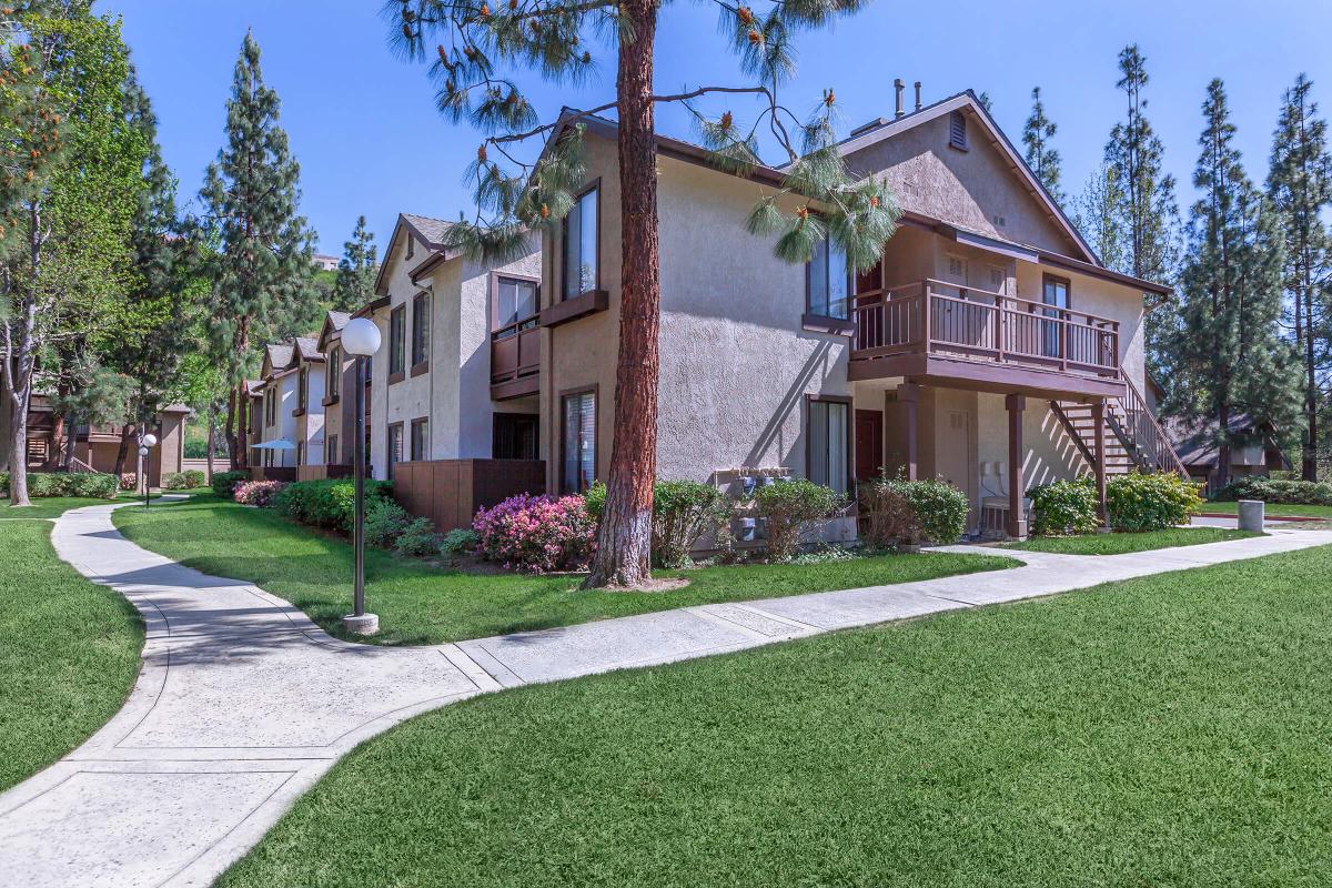 Emerald Court Apartment Homes community building with green grass