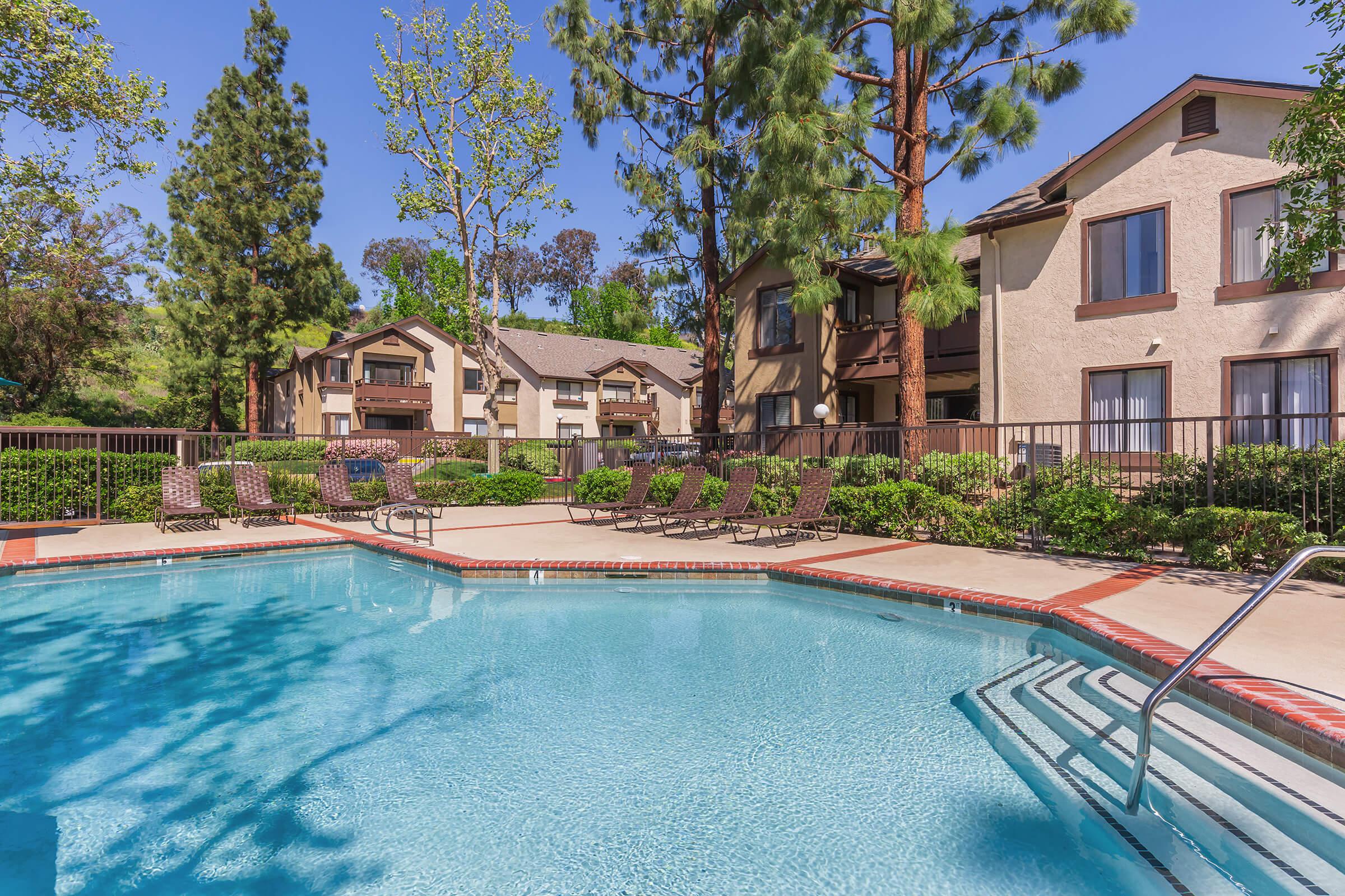 A community pool with green landscaping