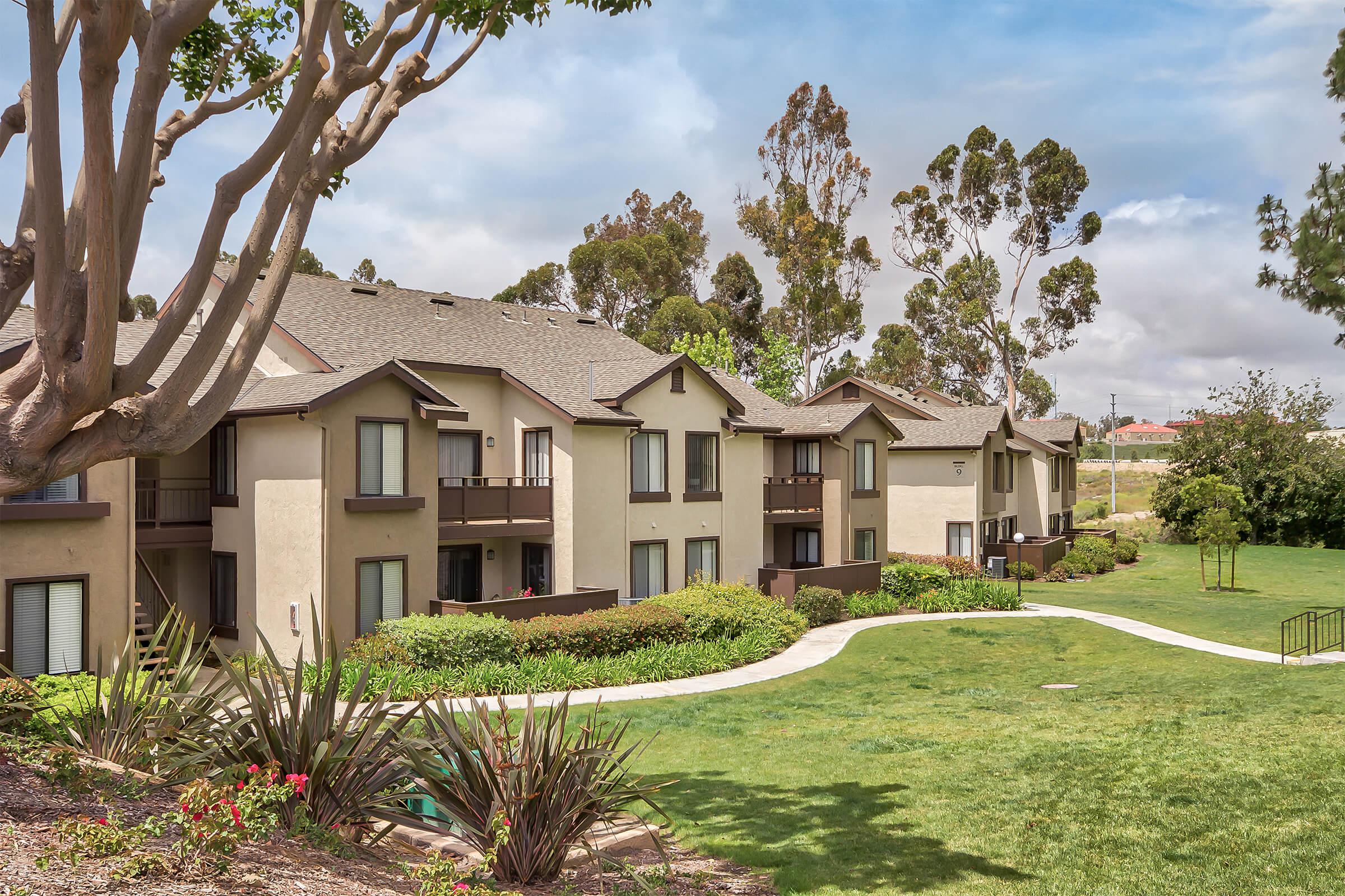 Emerald Court Apartment Homes community buildings with green grass