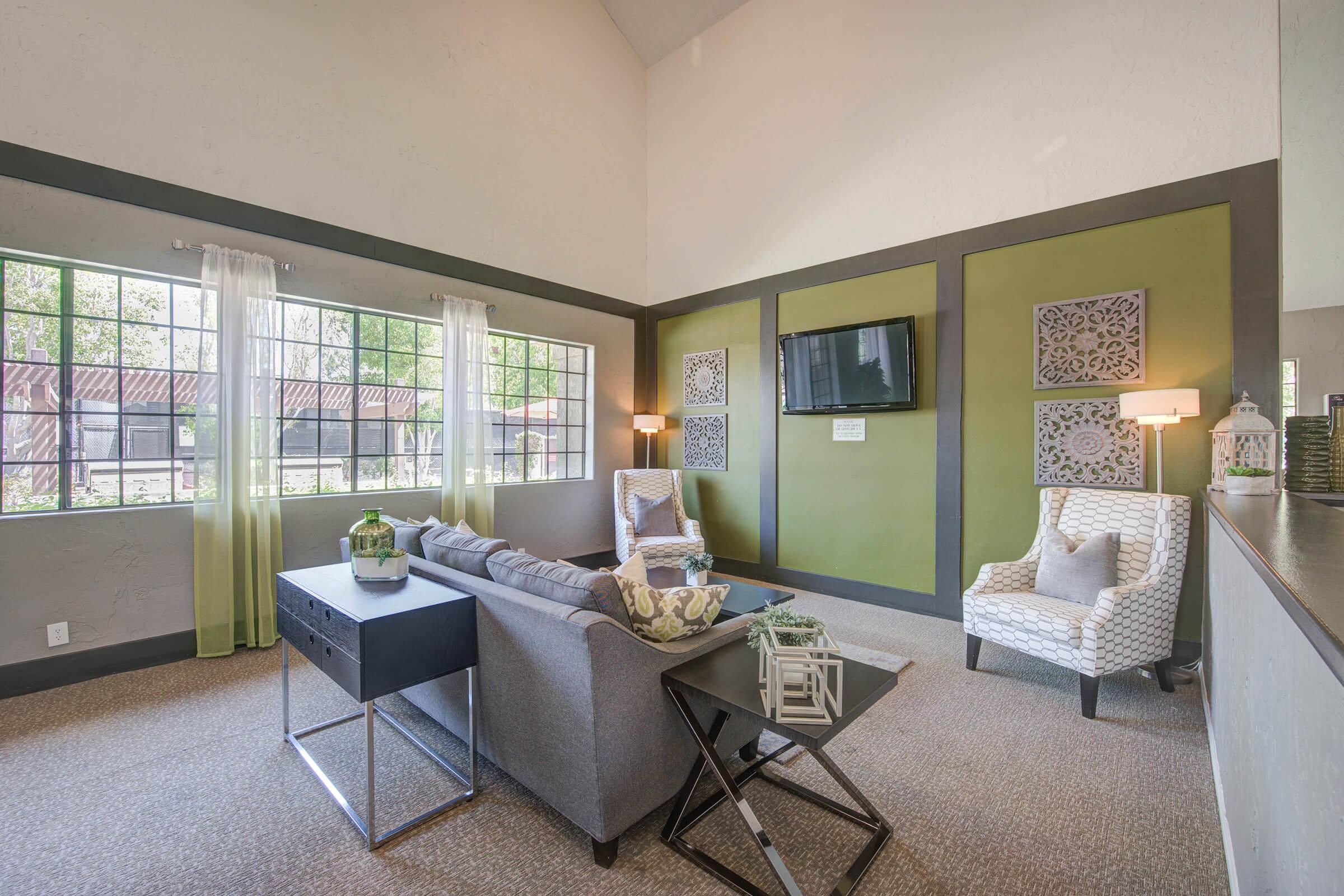 a living room filled with furniture and a large window