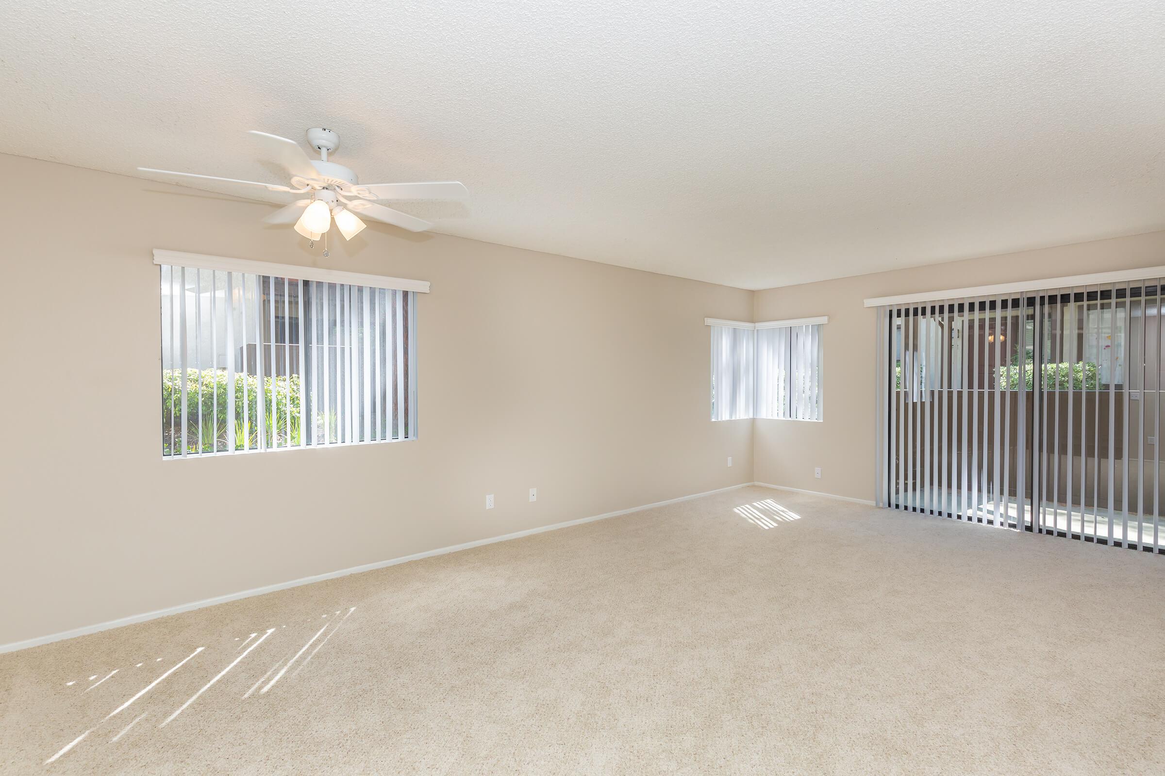 Carpeted living room with sliding glass doors