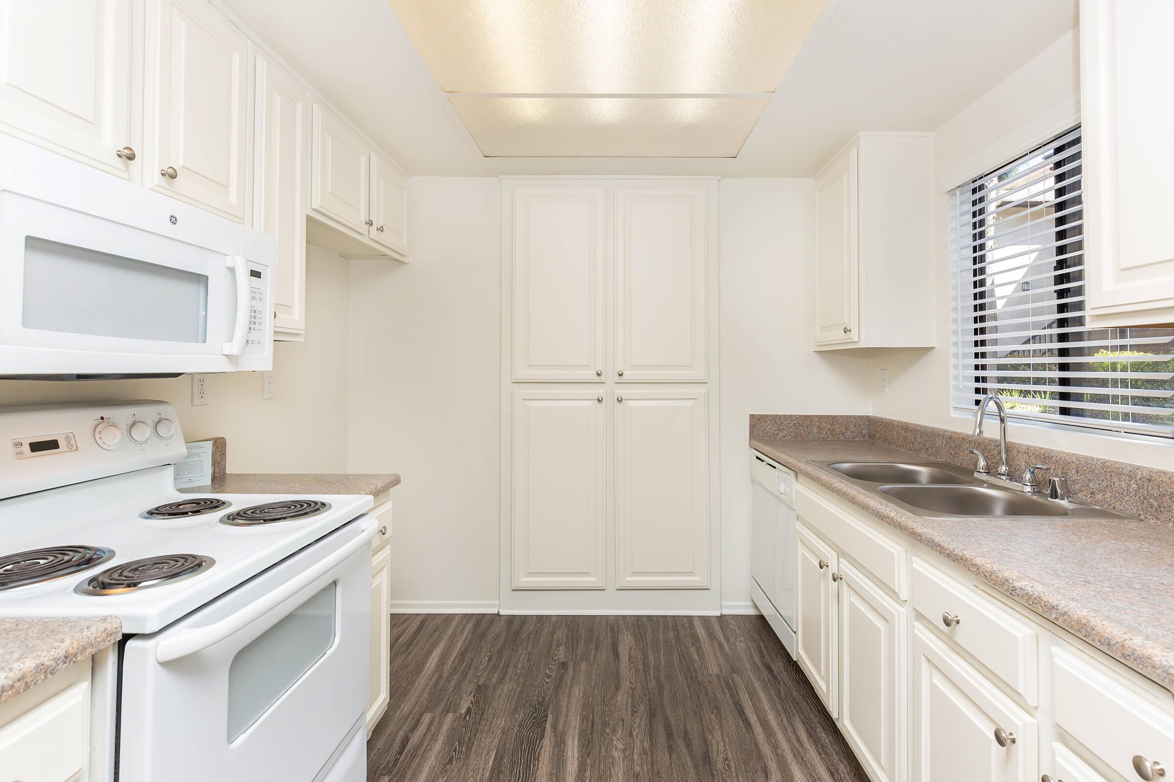 Unfurnished kitchen with white appliances