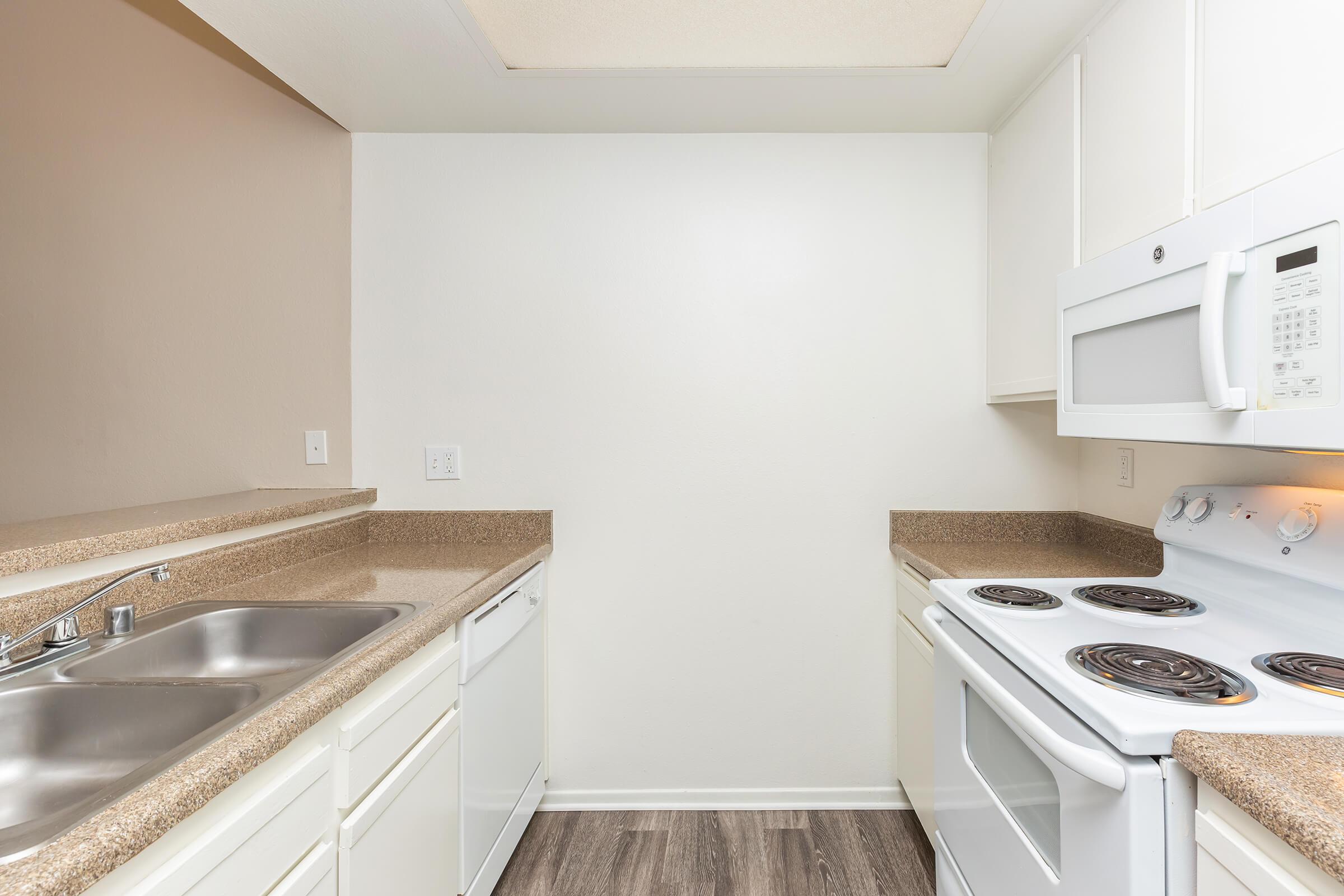 Unfurnished kitchen with white cabinets