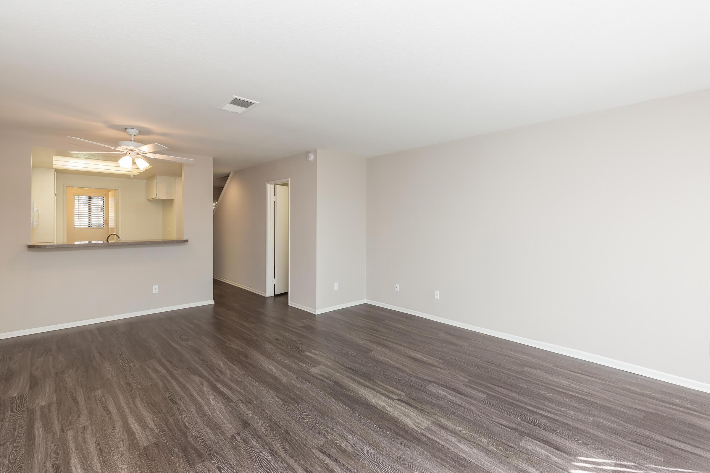 Unfurnished living room with wooden floors