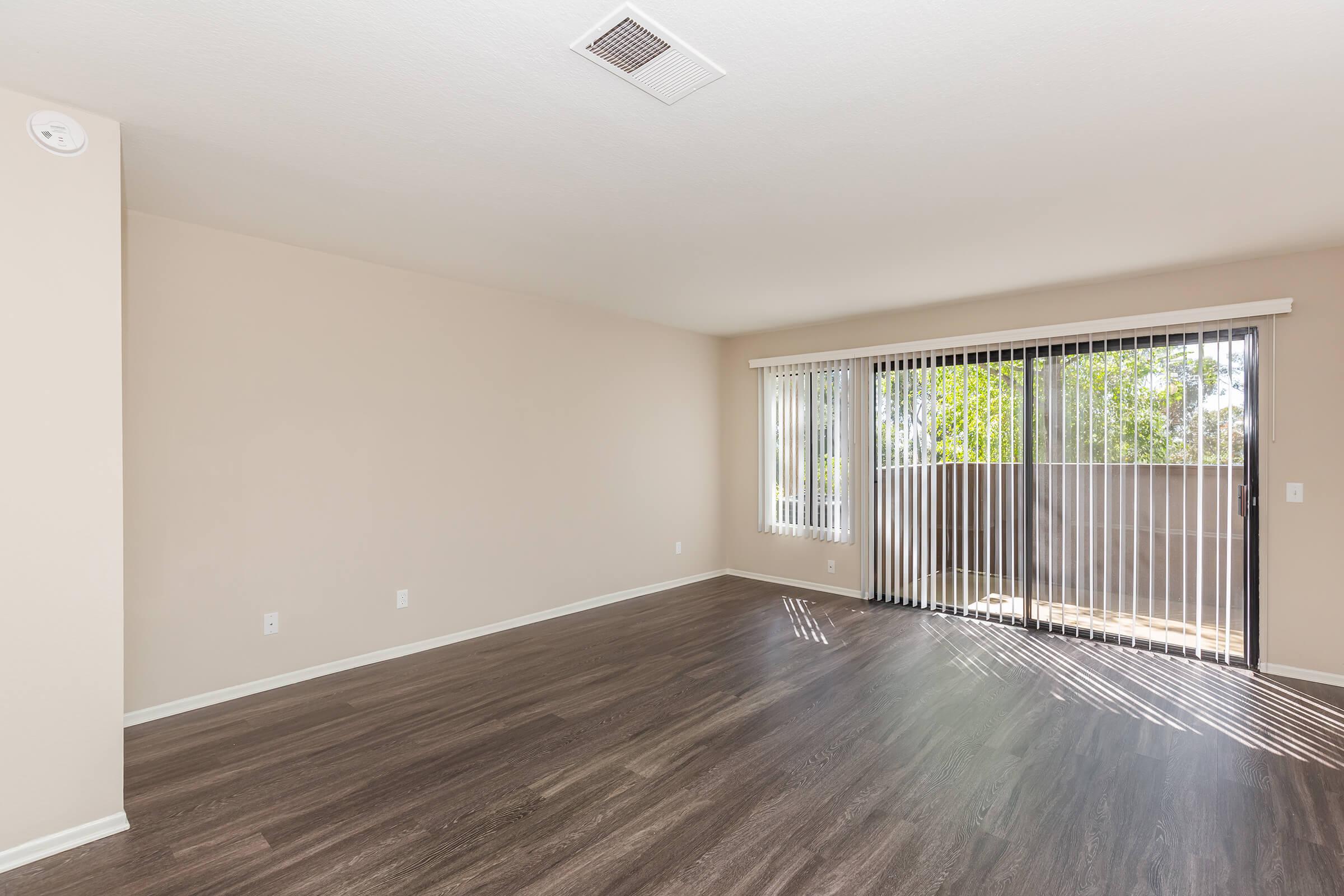 Unfurnished living room with sliding glass doors