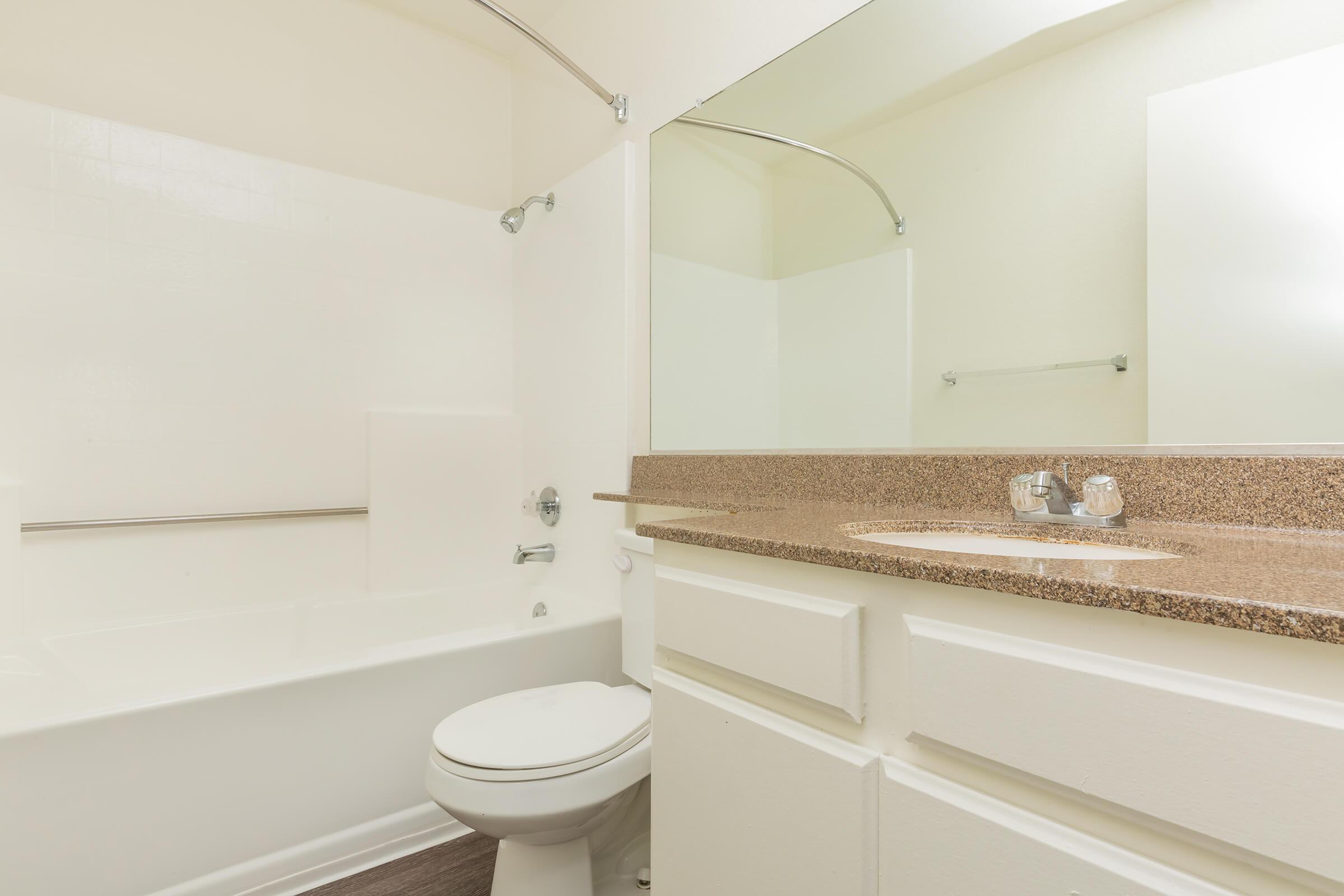 Vacant bathroom with white cabinets