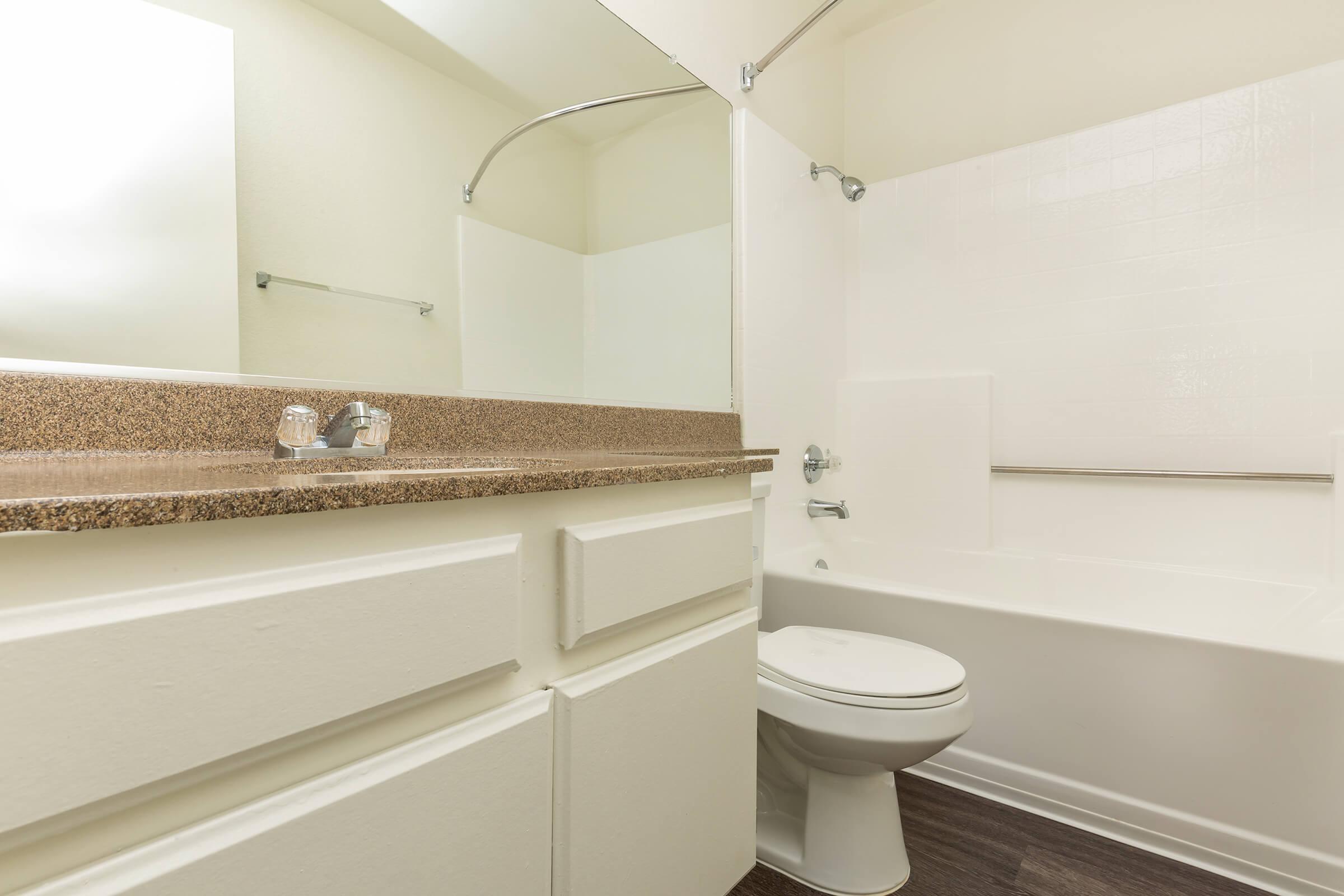 Vacant bathroom with wooden floors