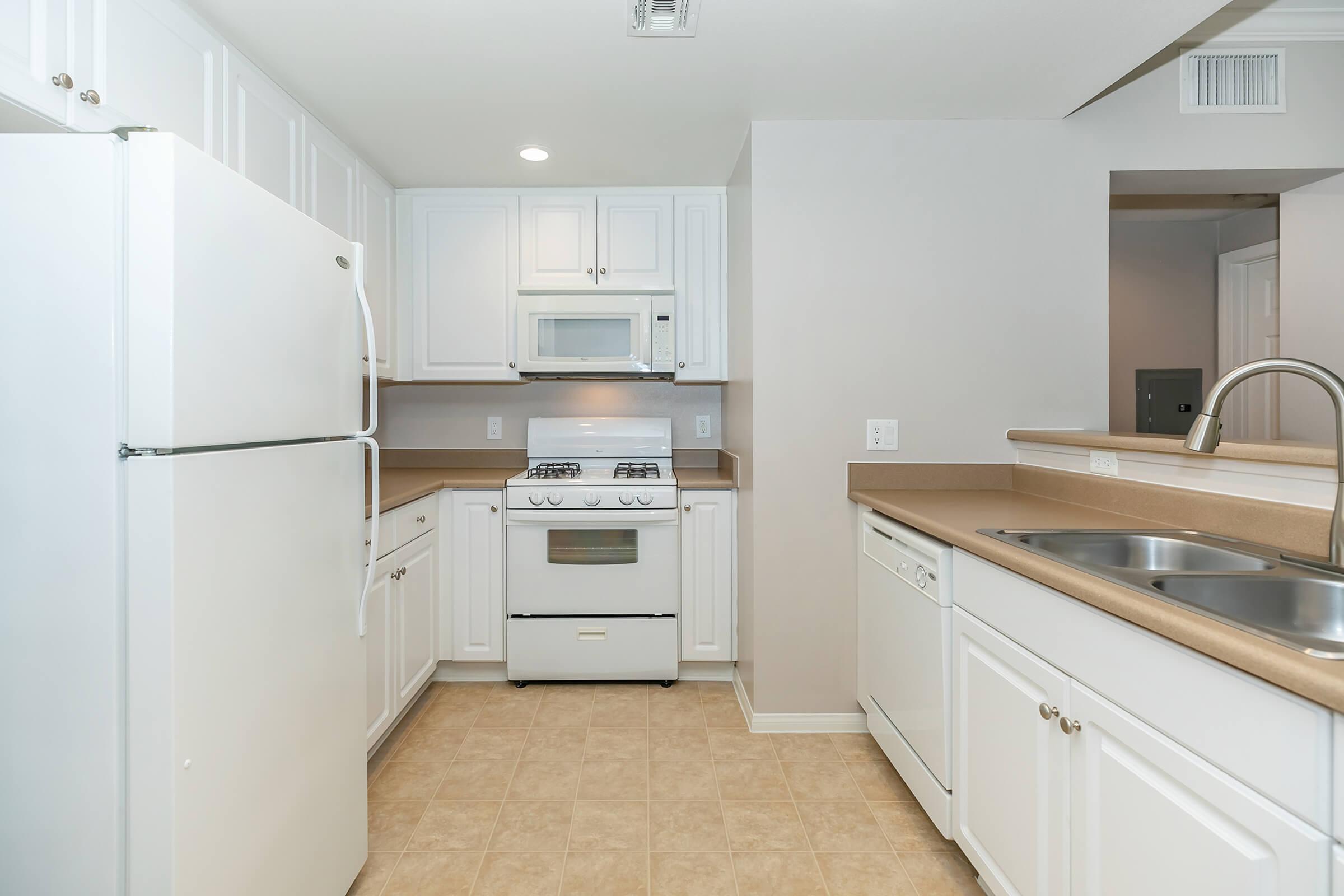 a kitchen with a stove and a refrigerator