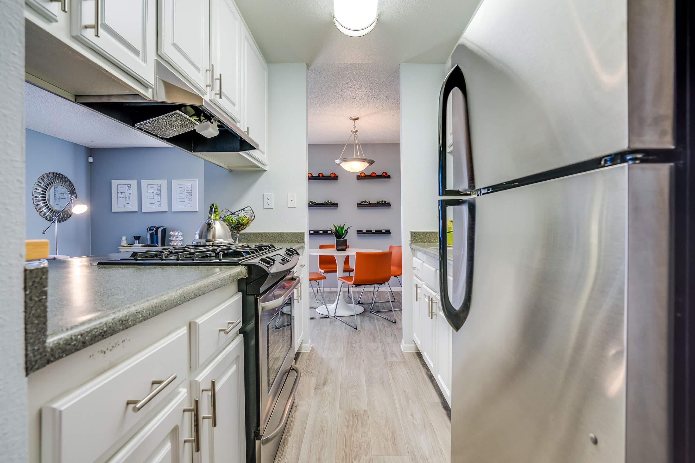 a kitchen with a stove sink and refrigerator