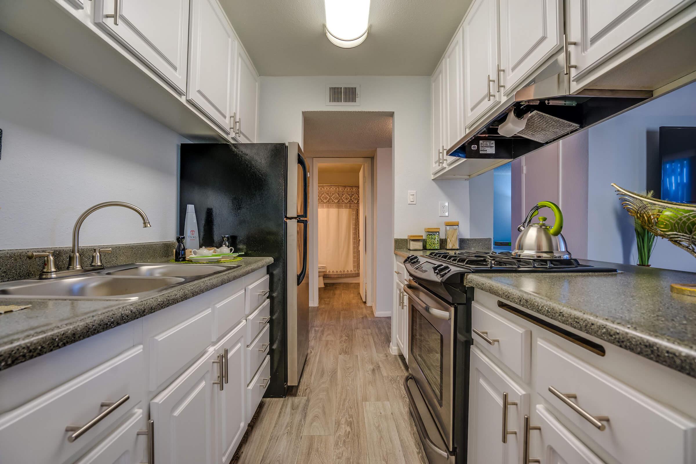 a kitchen with a stove and a sink