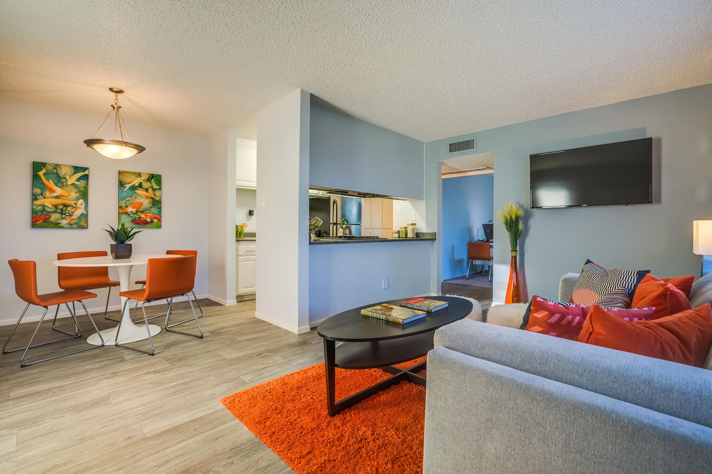 a living room filled with furniture and a flat screen tv