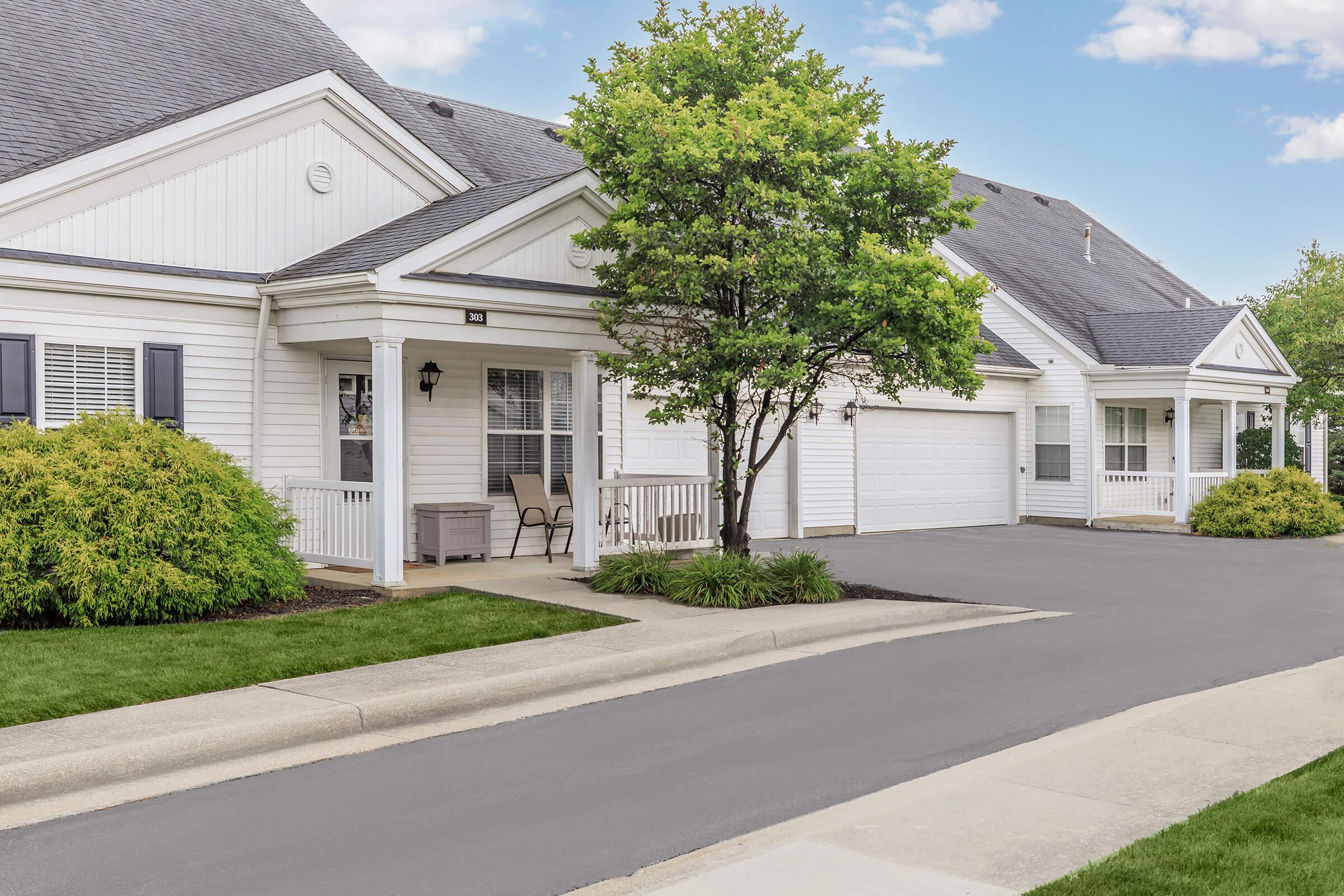 an empty road in front of a house