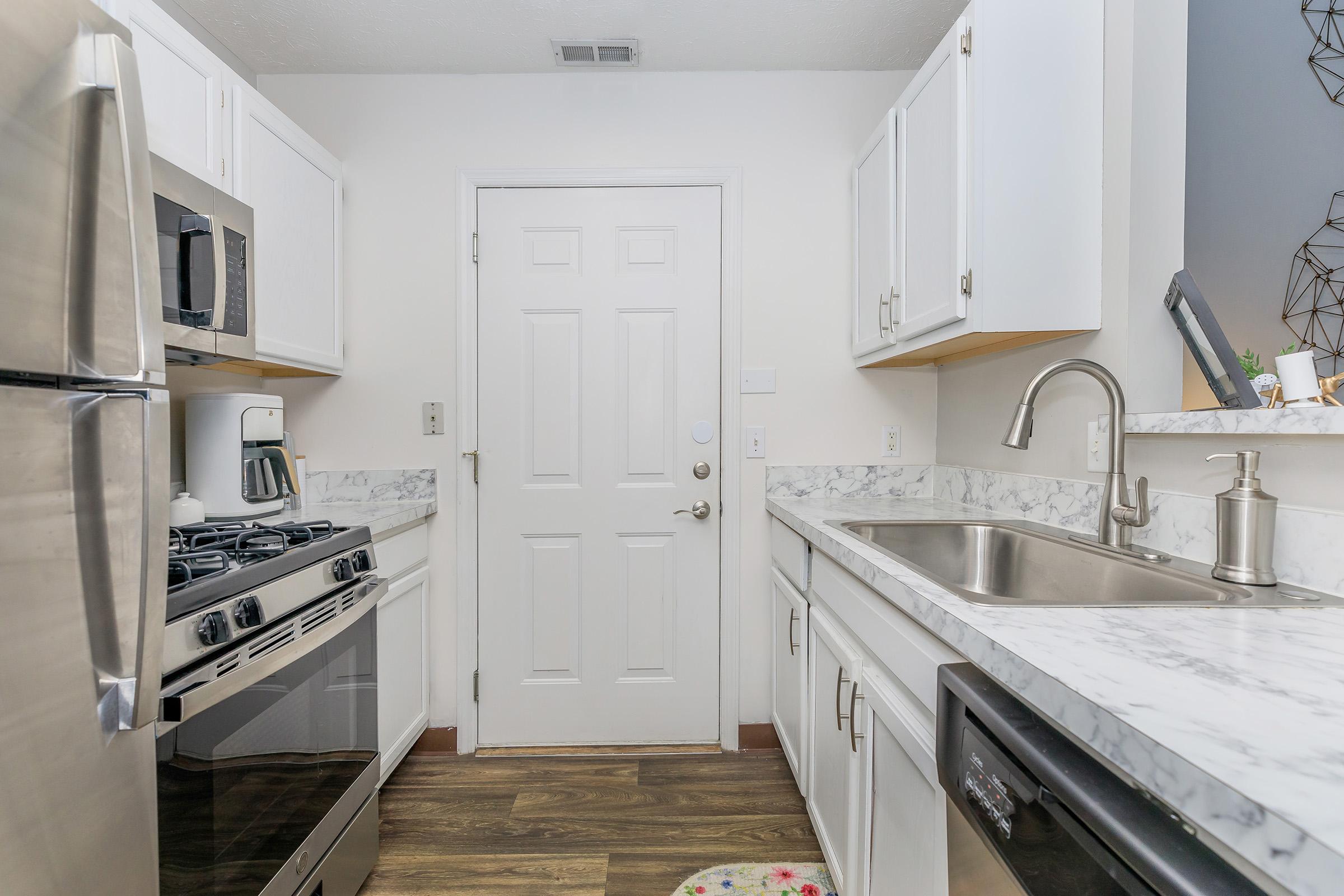 a kitchen with a stove sink and refrigerator