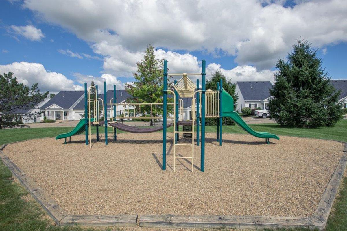 a green lawn chair on a playground