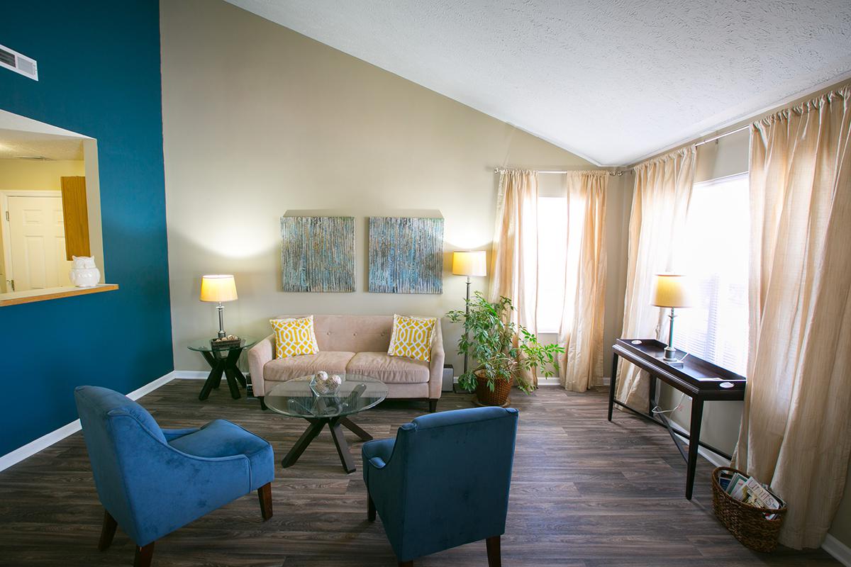 a living room filled with furniture and a window