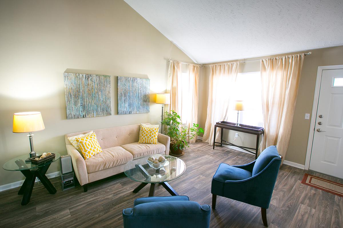 a living room filled with furniture and a large window