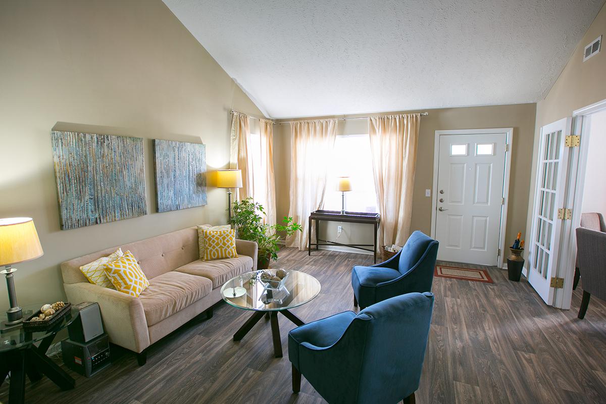 a living room filled with furniture and a large window