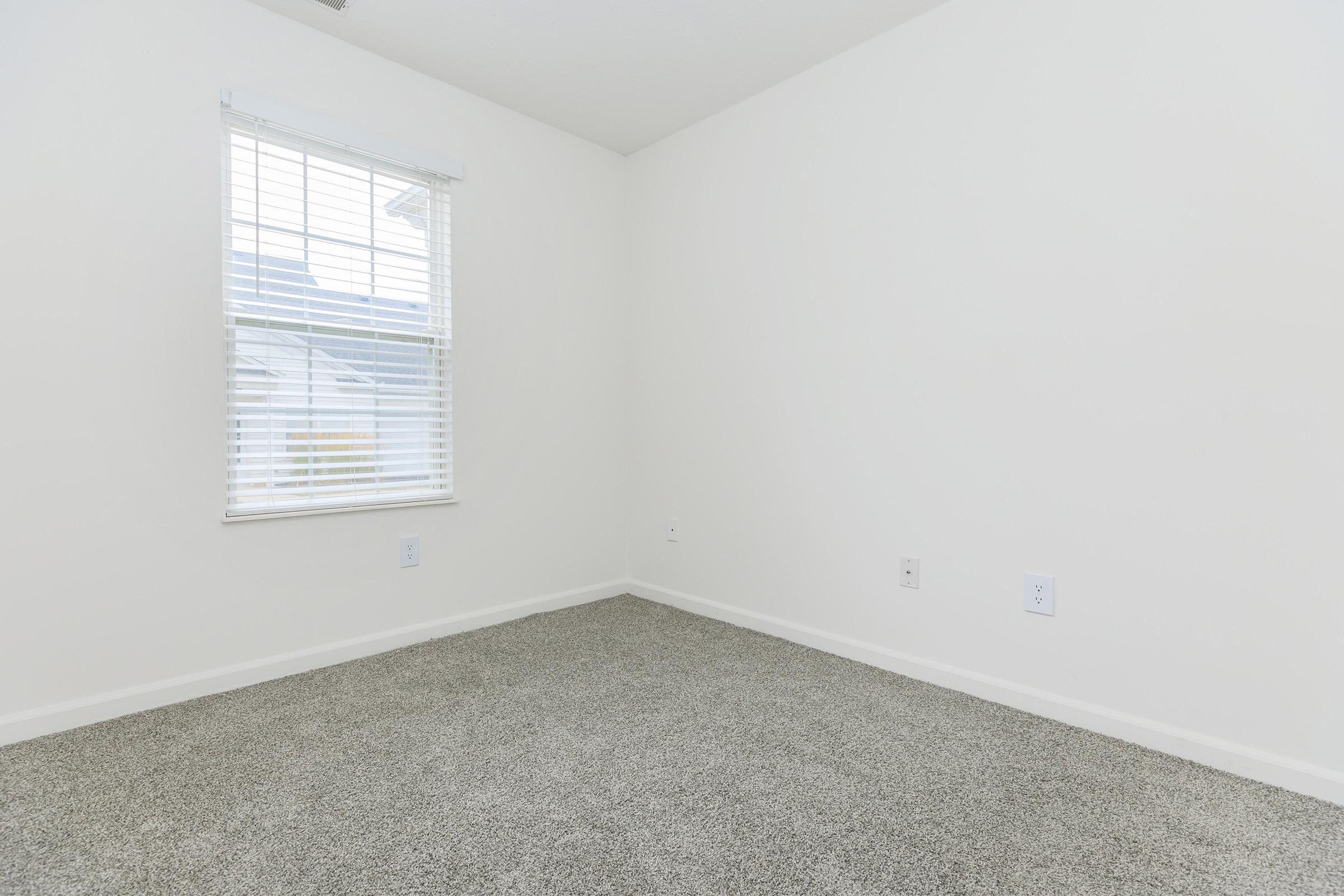 a bedroom with a building in the background