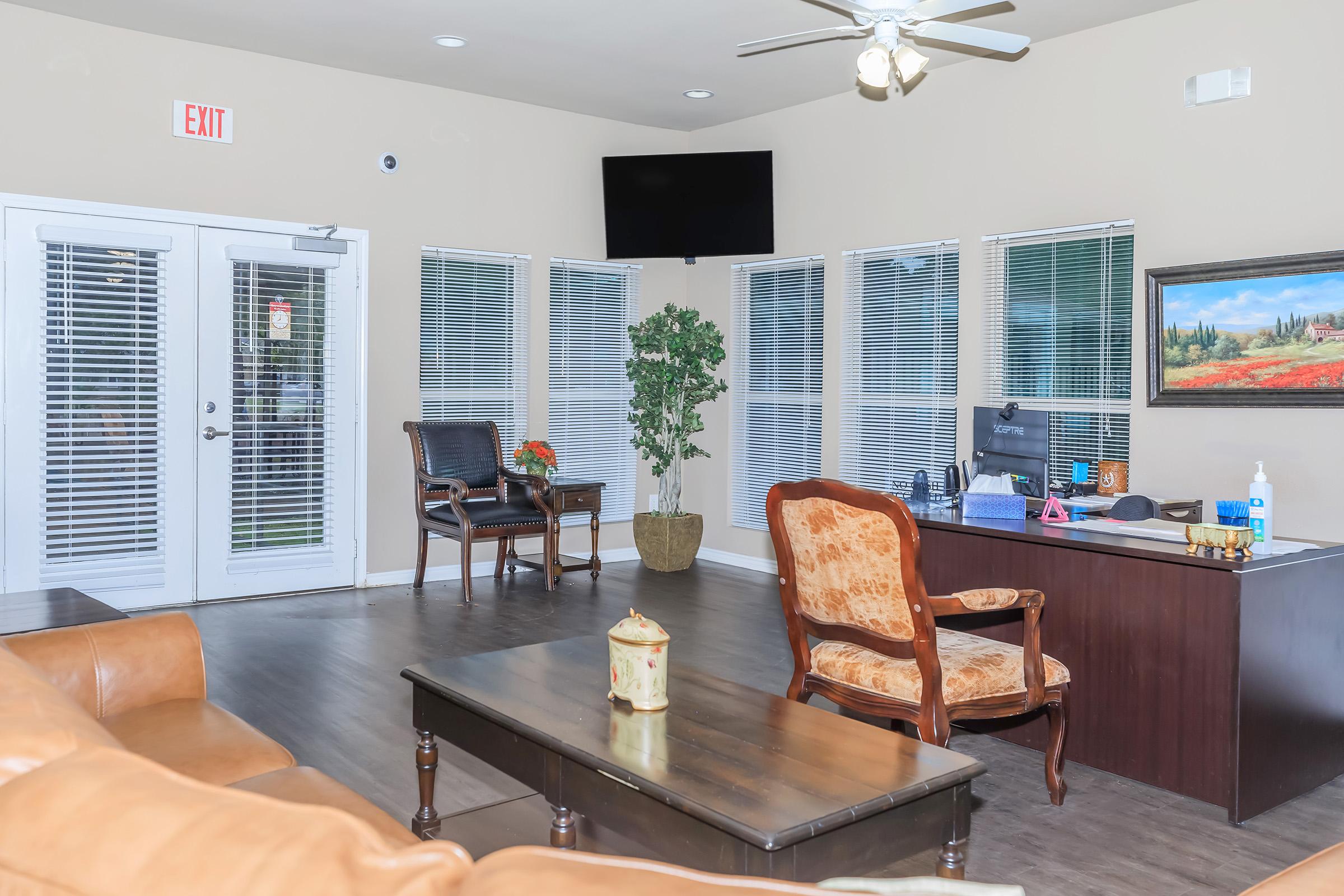 a living room filled with furniture and a flat screen tv