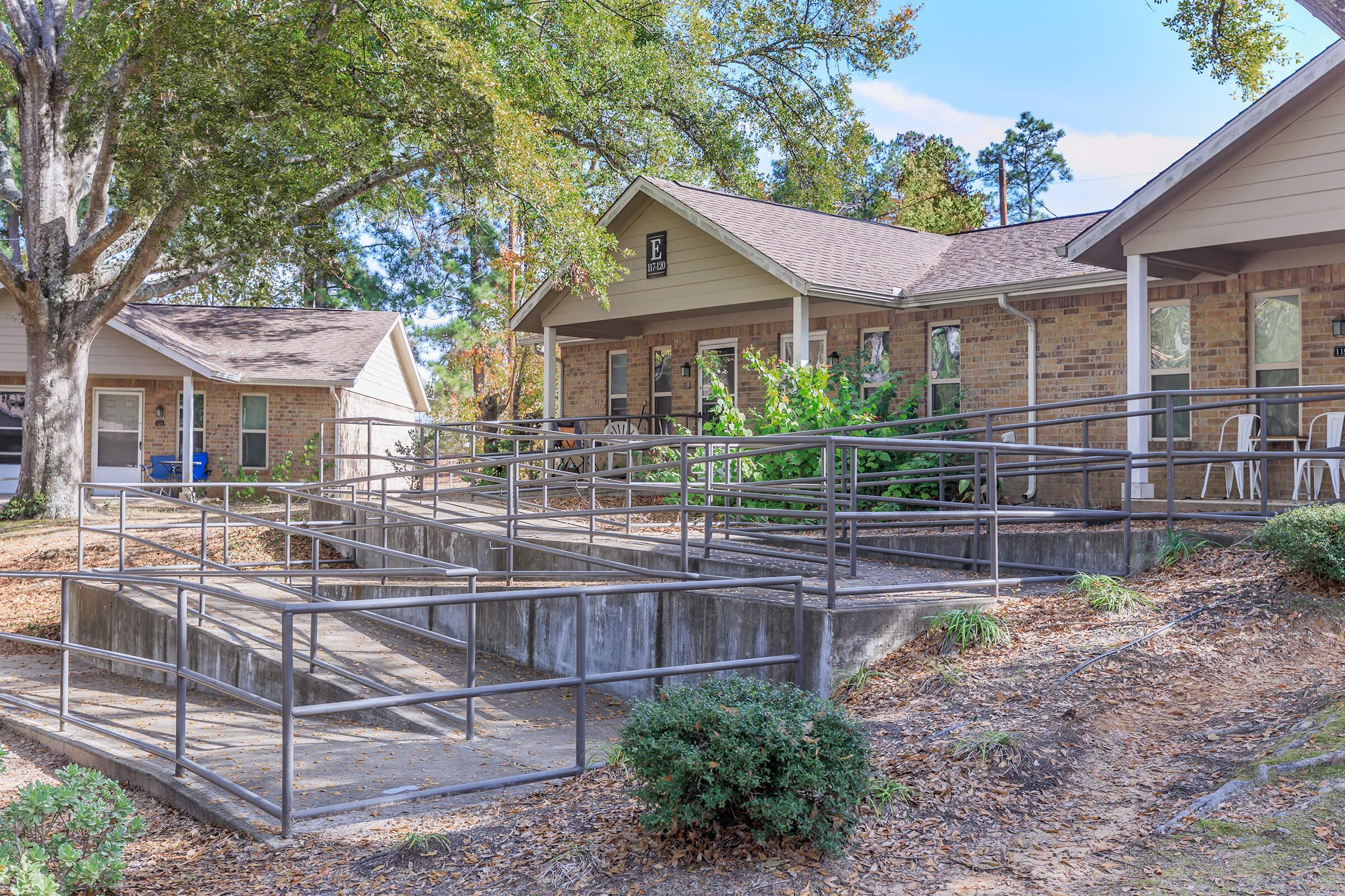 a house with a fence in front of a building