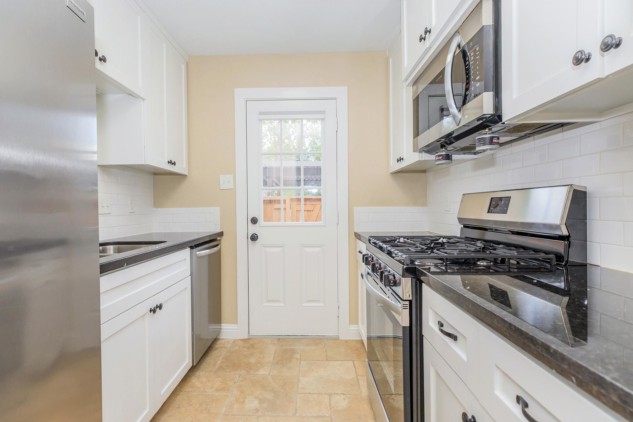 a kitchen with a stove top oven