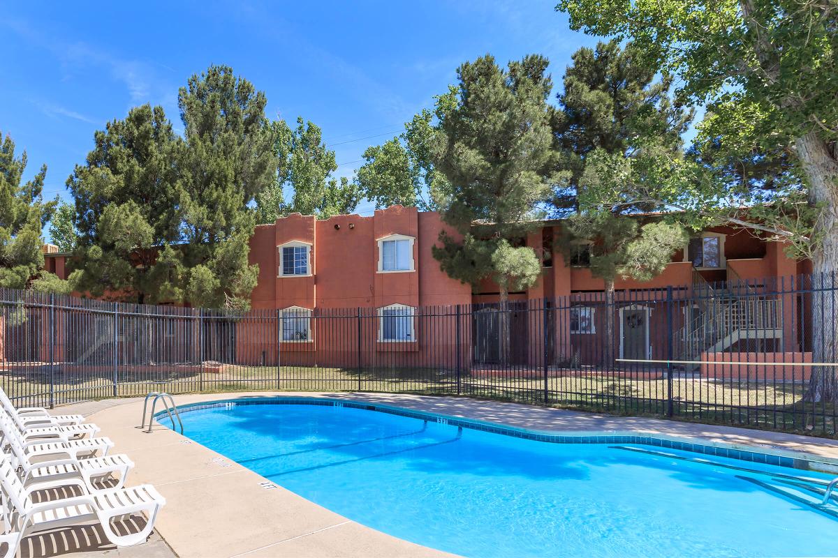 a group of lawn chairs sitting on top of a swimming pool