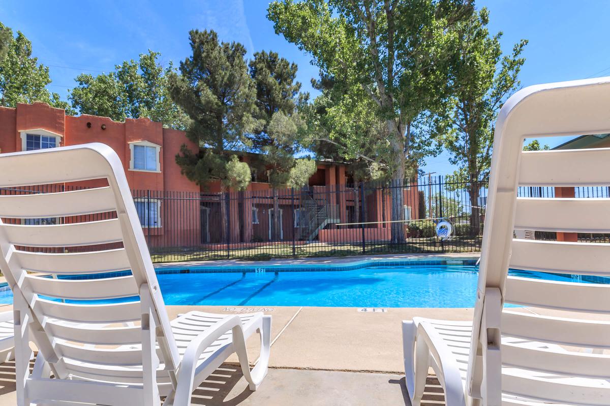 a couple of lawn chairs sitting on top of a wooden chair