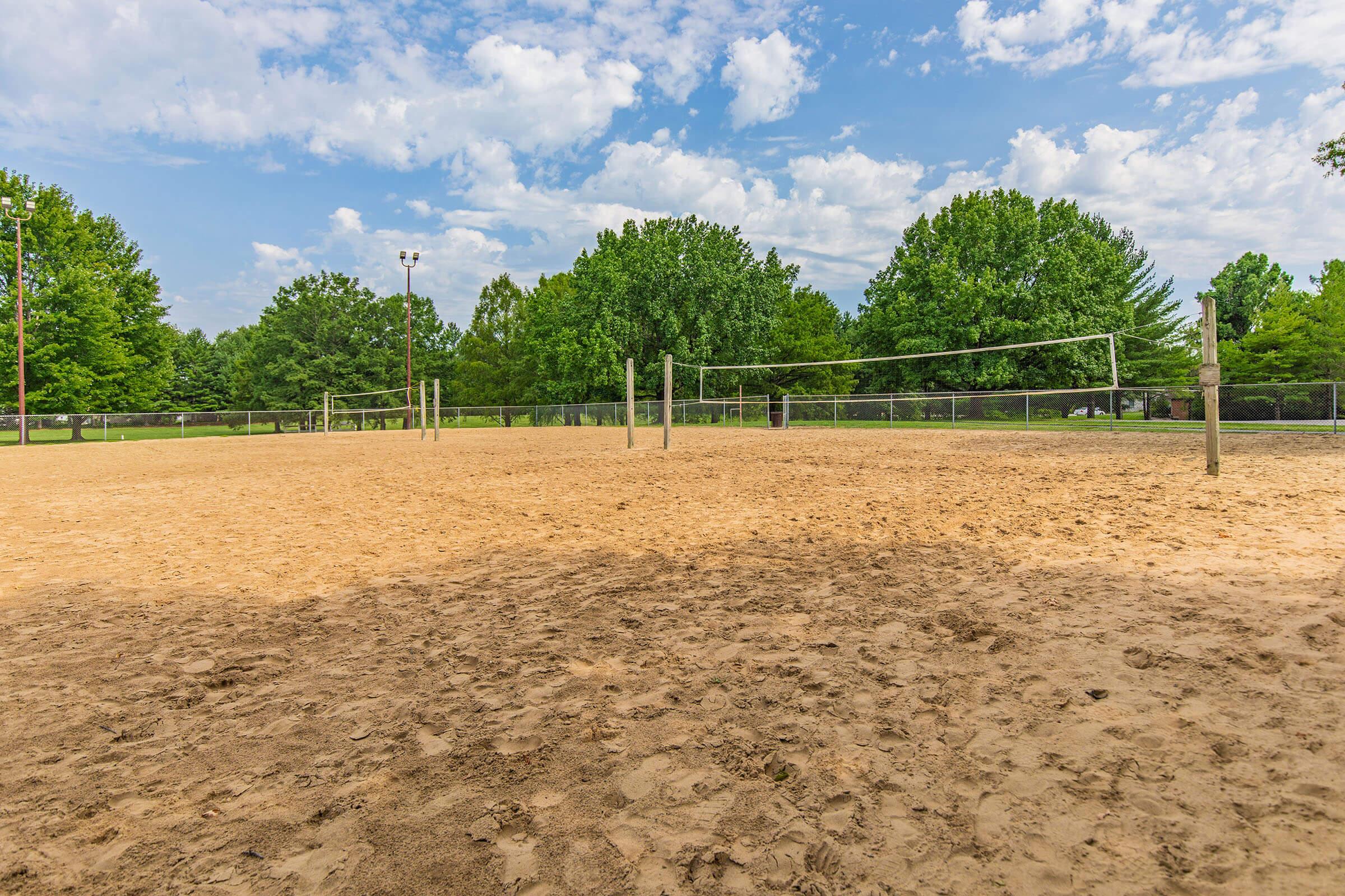 a group of people standing on top of a dirt field