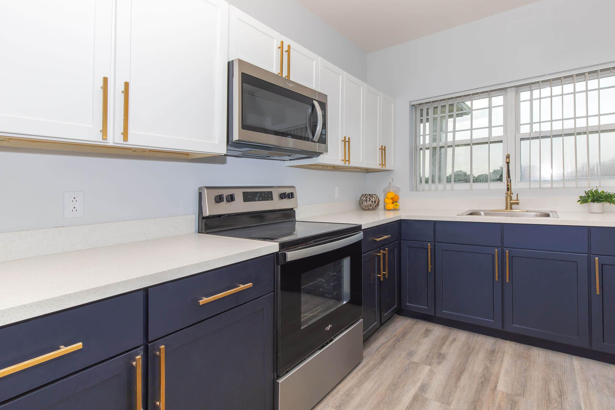 a modern kitchen with stainless steel appliances and wooden cabinets