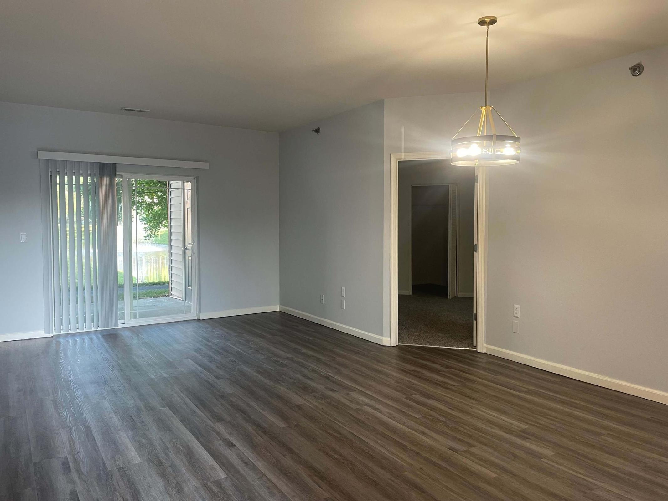 a large empty room with a wood floor