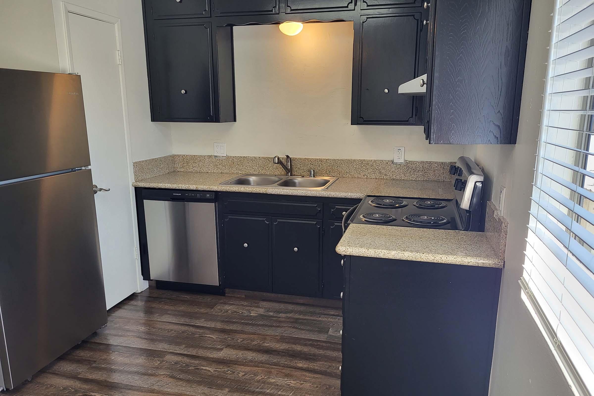 a kitchen with a sink and a mirror