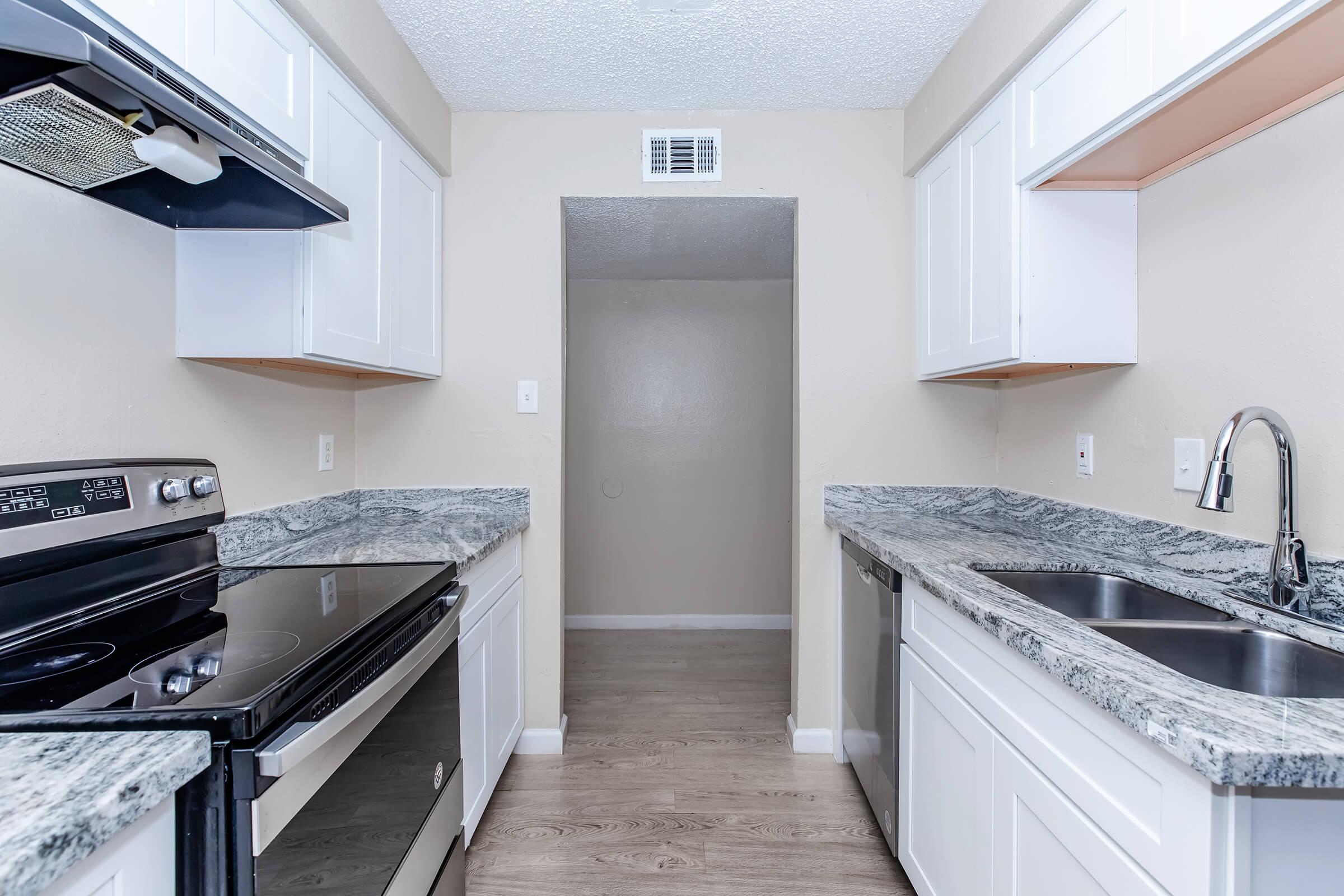 a kitchen with a stove top oven