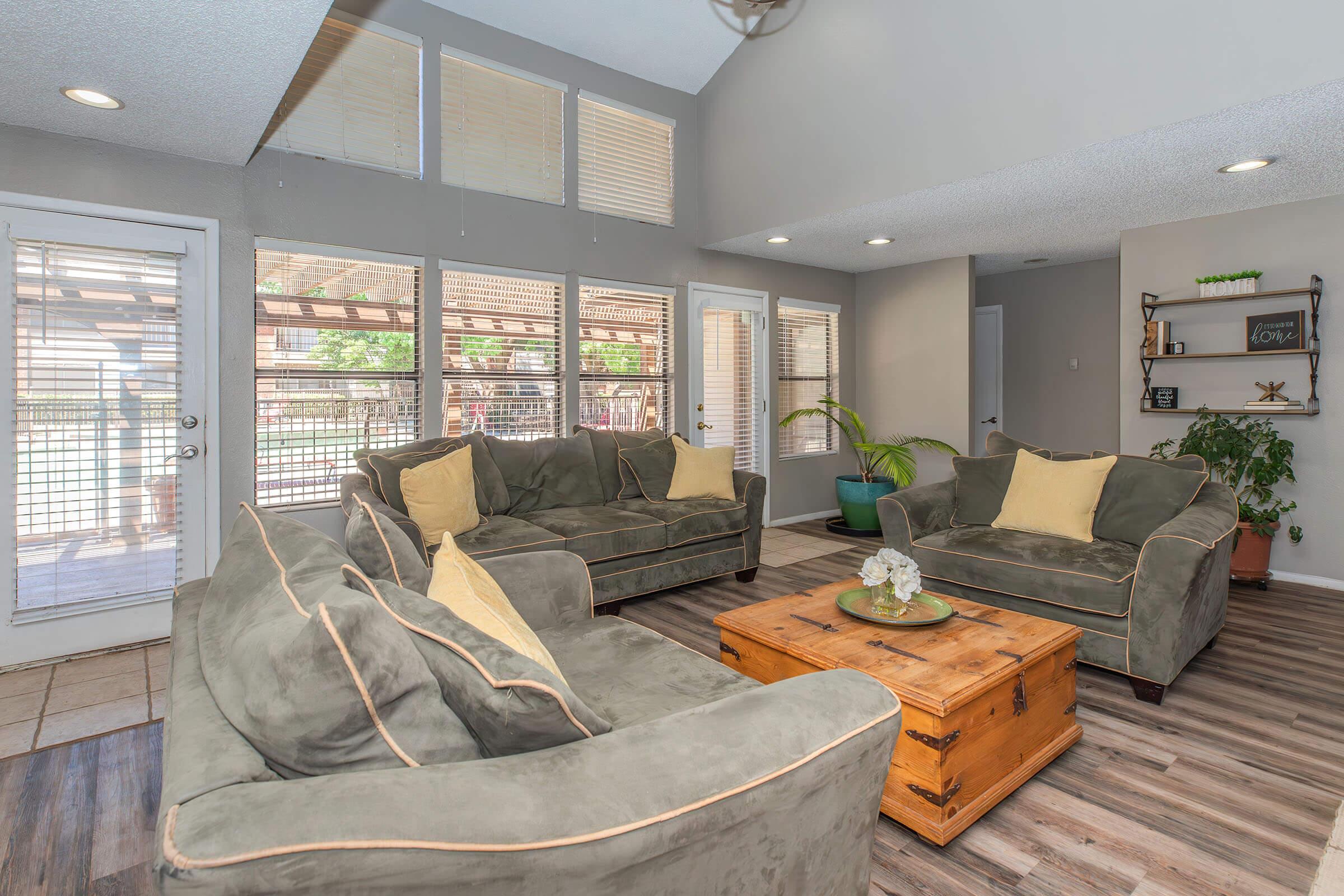 a living room filled with furniture and a large window