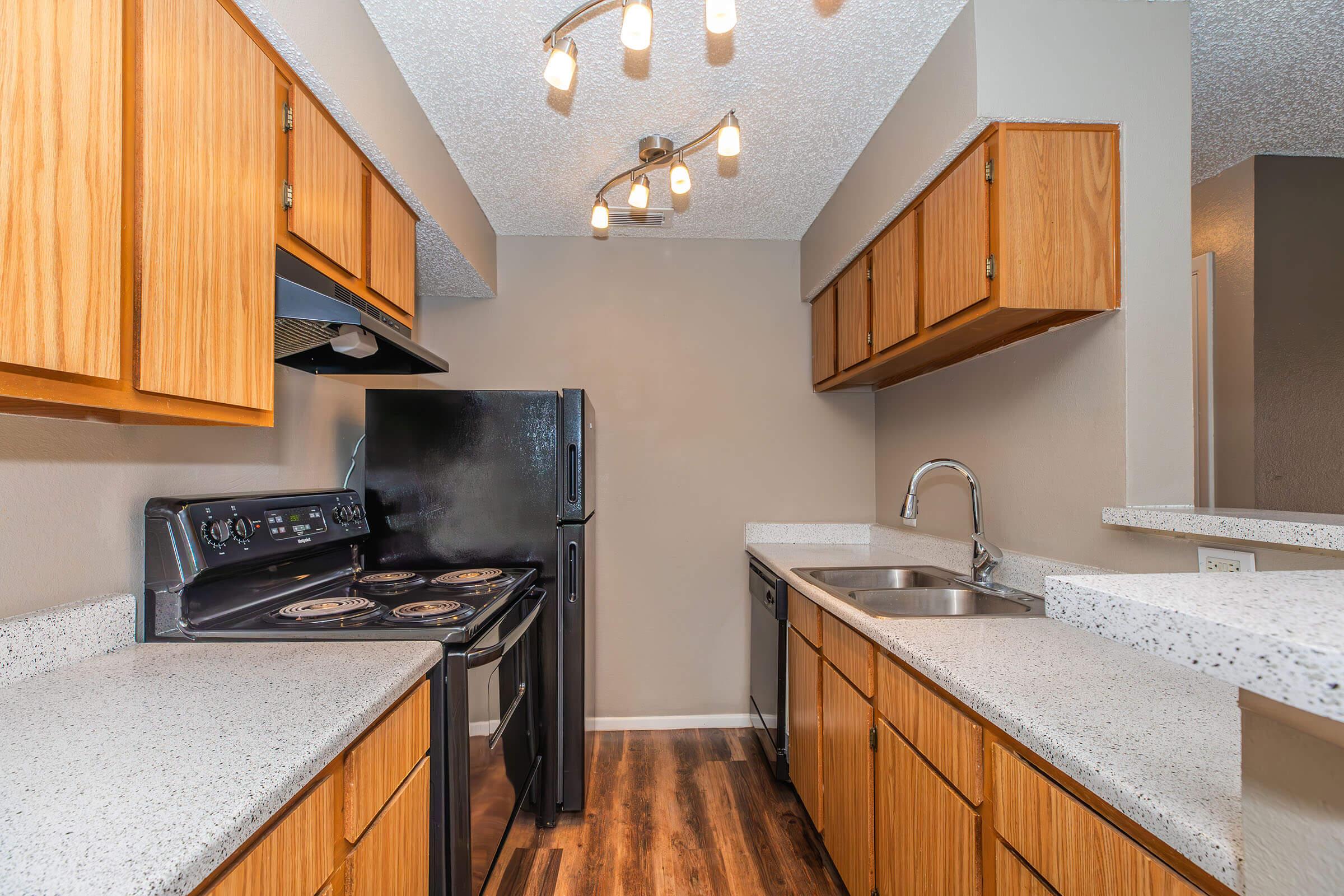 a kitchen with stainless steel appliances and wooden cabinets