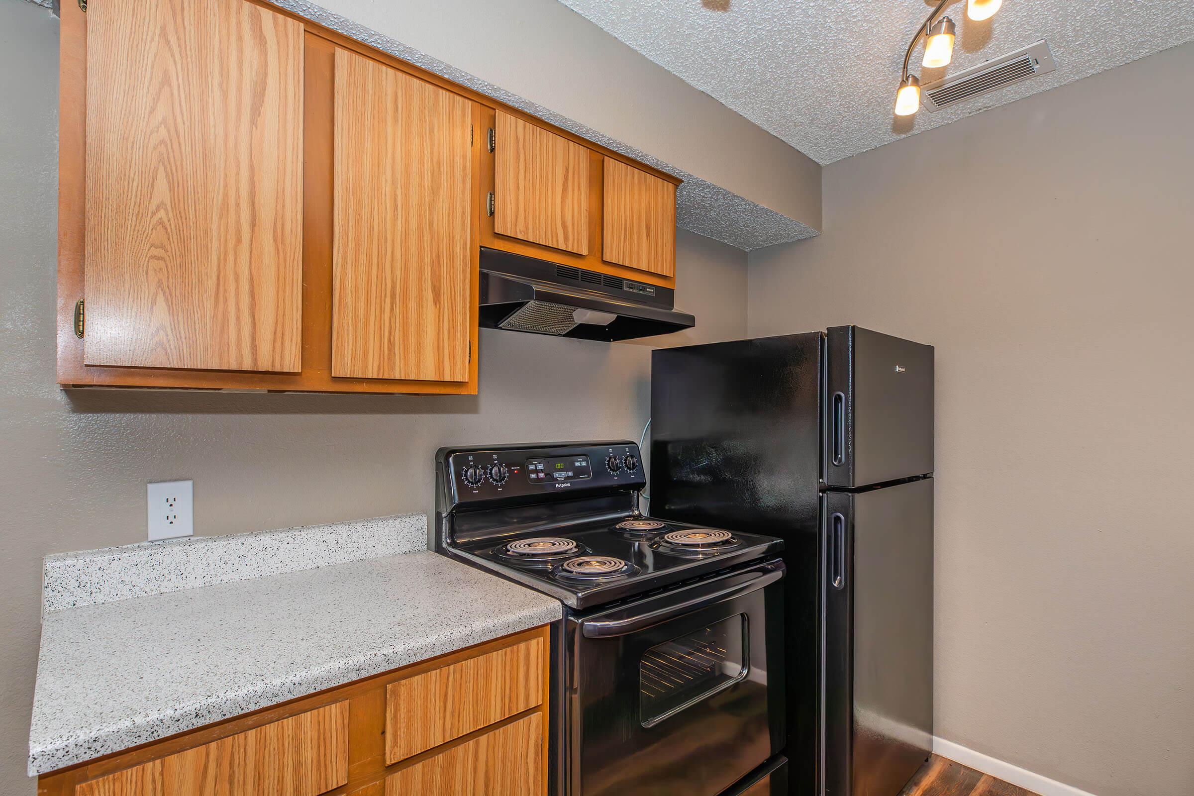 a kitchen with stainless steel appliances and wooden cabinets