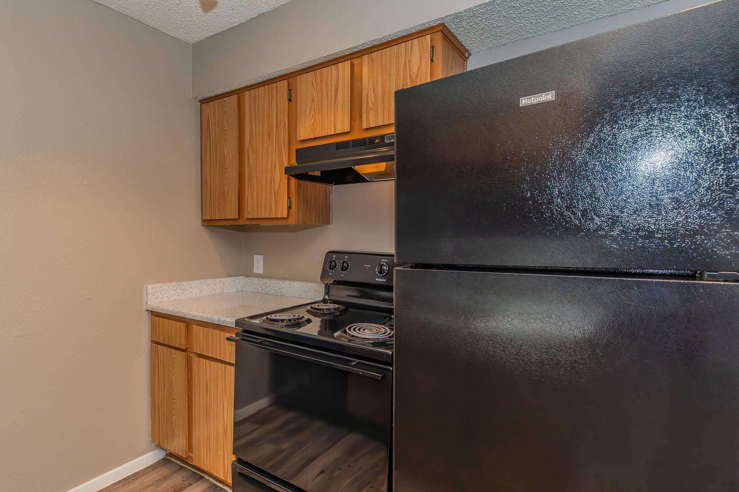 a kitchen with stainless steel appliances and wooden cabinets